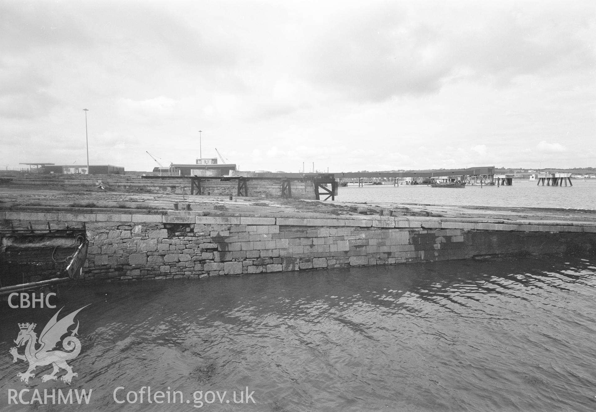 Digital copy of a black and white negative showing Old Royal Dockyard Pembroke - looking NW over ship building slip 11 to main seaplane launching ramp, taken by RCAHMW.