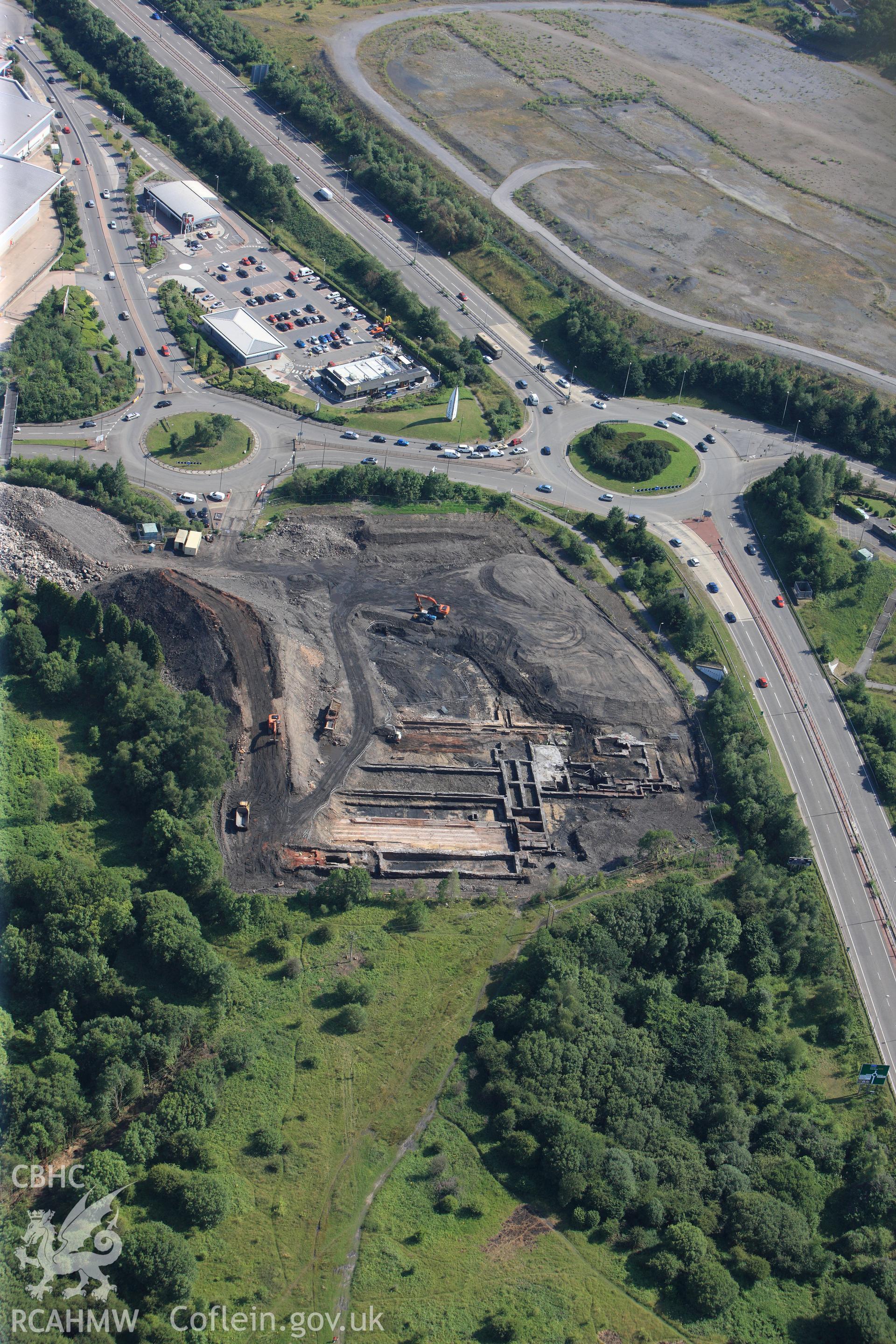 Site of former Rotax factory, and Cyfarthfa Ironworks including the remains of its blast furnaces, under excavation by Glamorgan-Gwent Archaeological Trust. Oblique aerial photograph taken during the Royal Commission?s programme of archaeological aerial reconnaissance by Toby Driver on 1st August 2013.