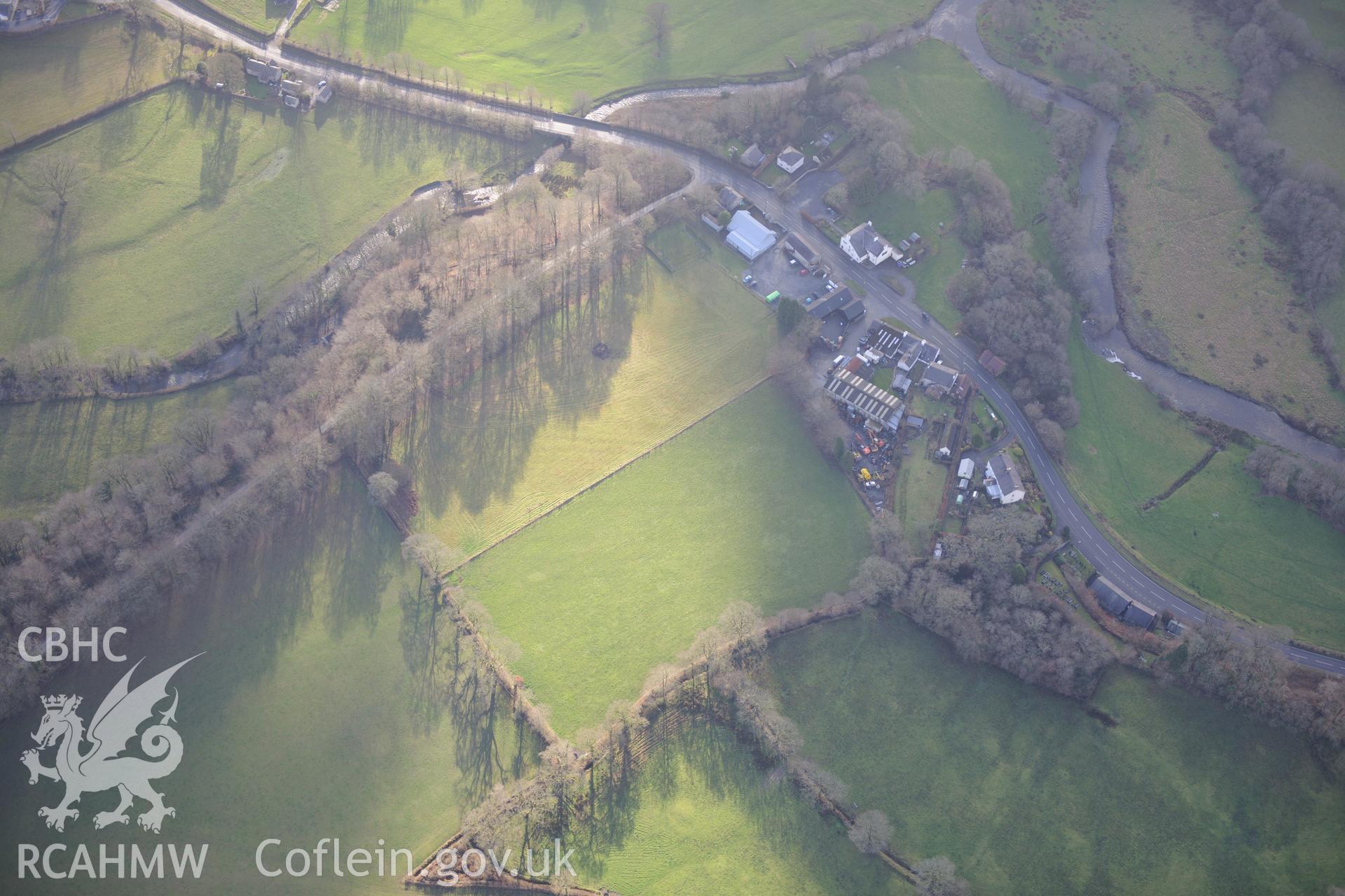 Pumpsaint, including views of Dolaucothi Lodge and stables; Dolaucothi Arms; Pumpsaint Post Office and Pumsaint Bridge. Oblique aerial photograph taken during the Royal Commission's programme of archaeological aerial reconnaissance by Toby Driver on 6th January 2015.