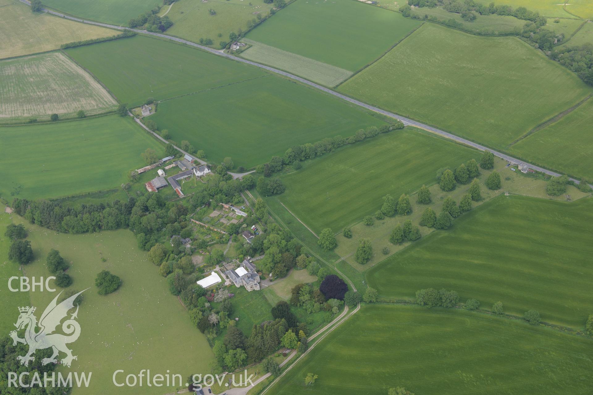 Hampton Court and garden; Hampton Court lodge; Garden House; defended enclosure; parallel linear ditches and Roman fortlet. Oblique aerial photograph taken during the Royal Commission's programme of archaeological aerial reconnaissance by Toby Driver on 11th June 2015.