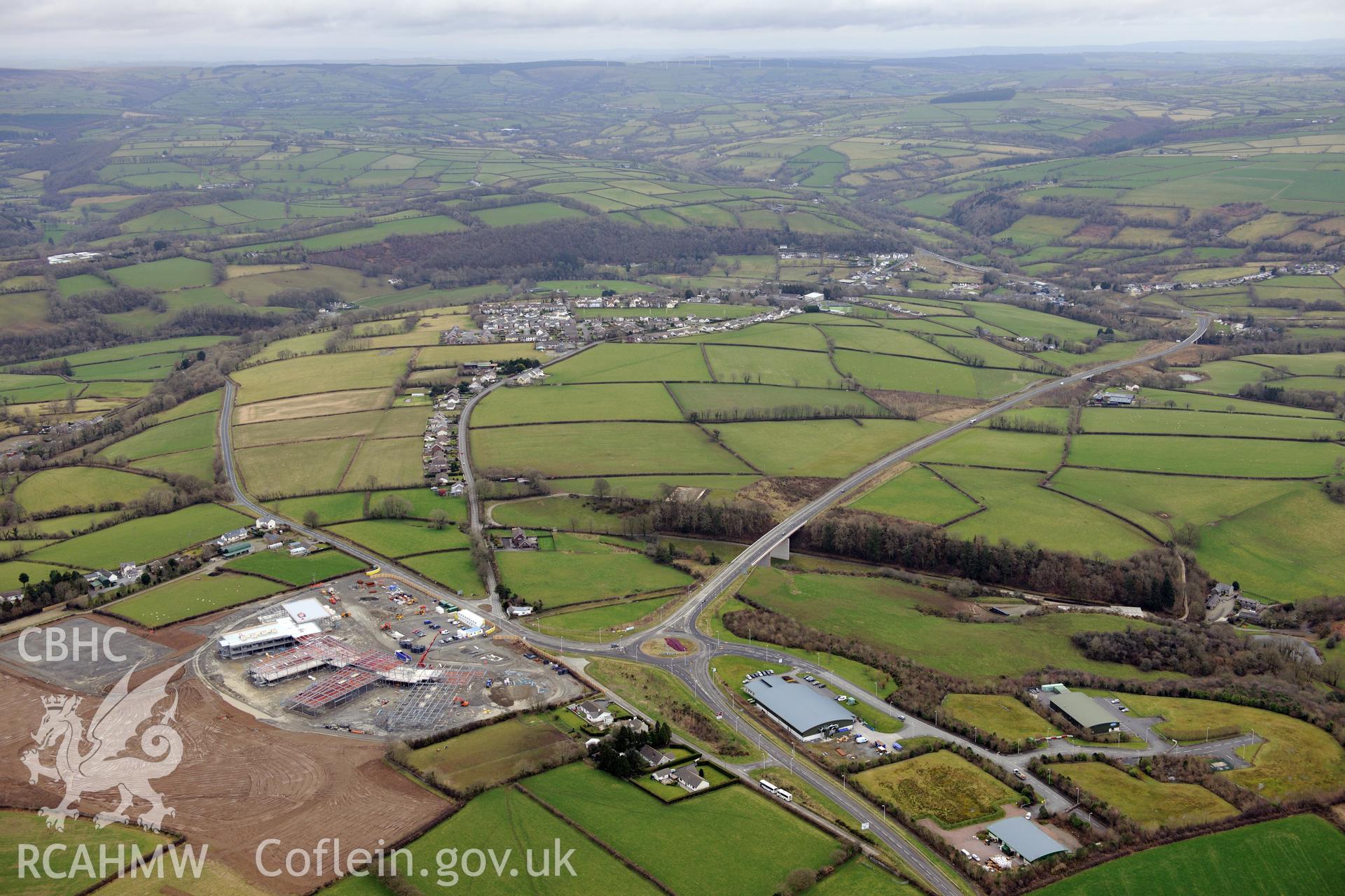 Ysgol Bro Teifi under construction, the A486 Llandysul bypass, and the town of Llandysul beyond. Oblique aerial photograph taken during the Royal Commission's programme of archaeological aerial reconnaissance by Toby Driver on 13th March 2015.