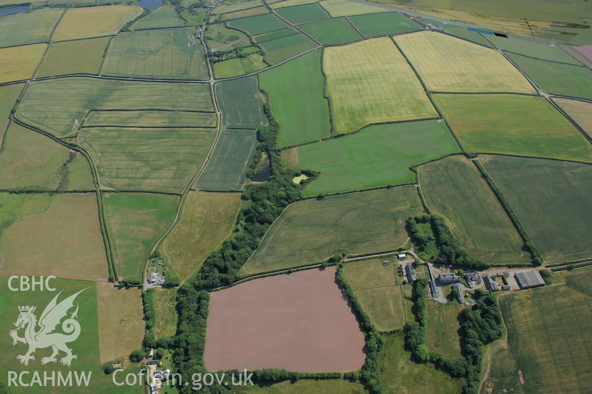 Butterhill farm with cropmarks east south south of the main farm buildings, near St Ishmaels. Oblique aerial photograph taken during the Royal Commission?s programme of archaeological aerial reconnaissance by Toby Driver on 16th July 2013.