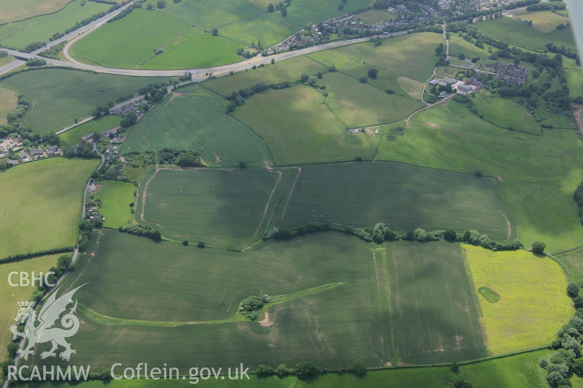 Raglan Castle, attached gardens, and siegework north-east of Raglan Castle. Oblique aerial photograph taken during the Royal Commission's programme of archaeological aerial reconnaissance by Toby Driver on 29th June 2015.