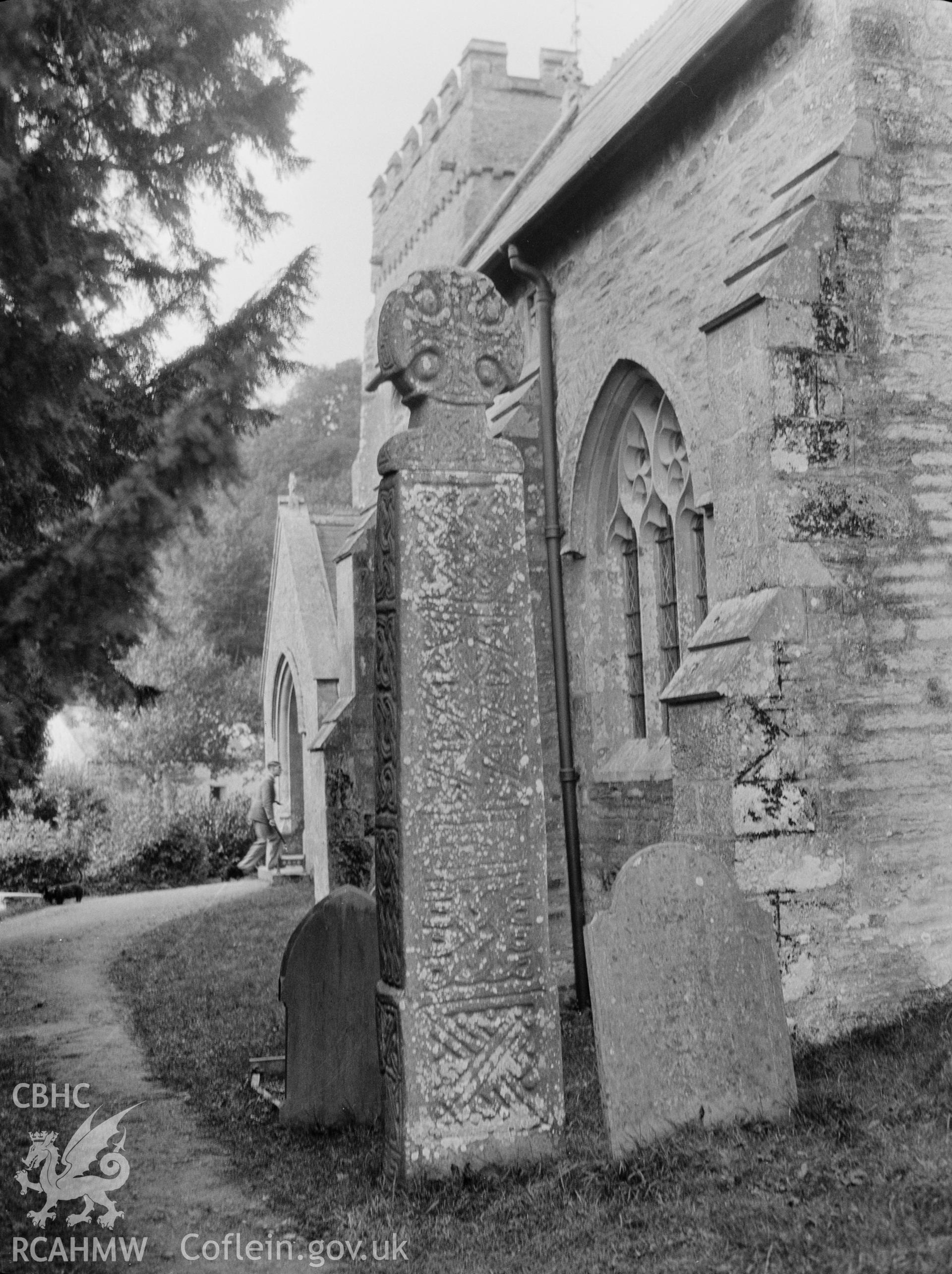 Digital copy of a nitrate negative showing the east face of St Brynach's Cross in the churchyard of St Brynach's Church, Nevern. From the National Building Record Postcard Collection.