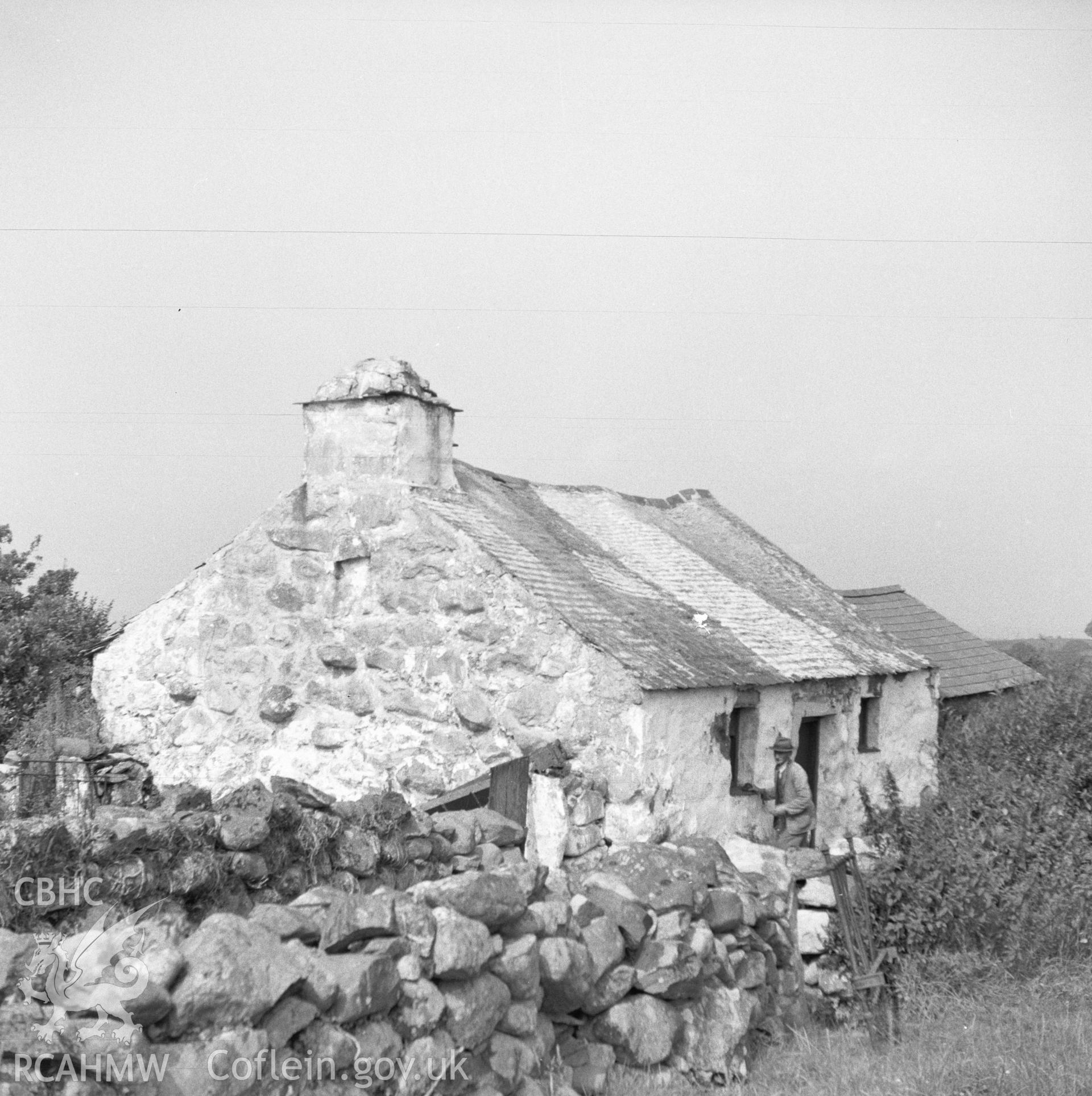 Digital copy of a nitrate negative showing exterior view of cottage to be relocated at the Folk Museum.