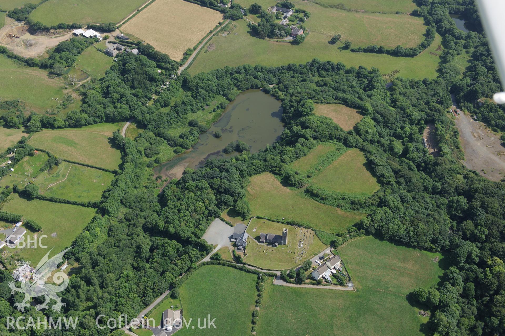 Walwyns Castle and St James's Church. Oblique aerial photograph taken during the Royal Commission?s programme of archaeological aerial reconnaissance by Toby Driver on 16th July 2013.
