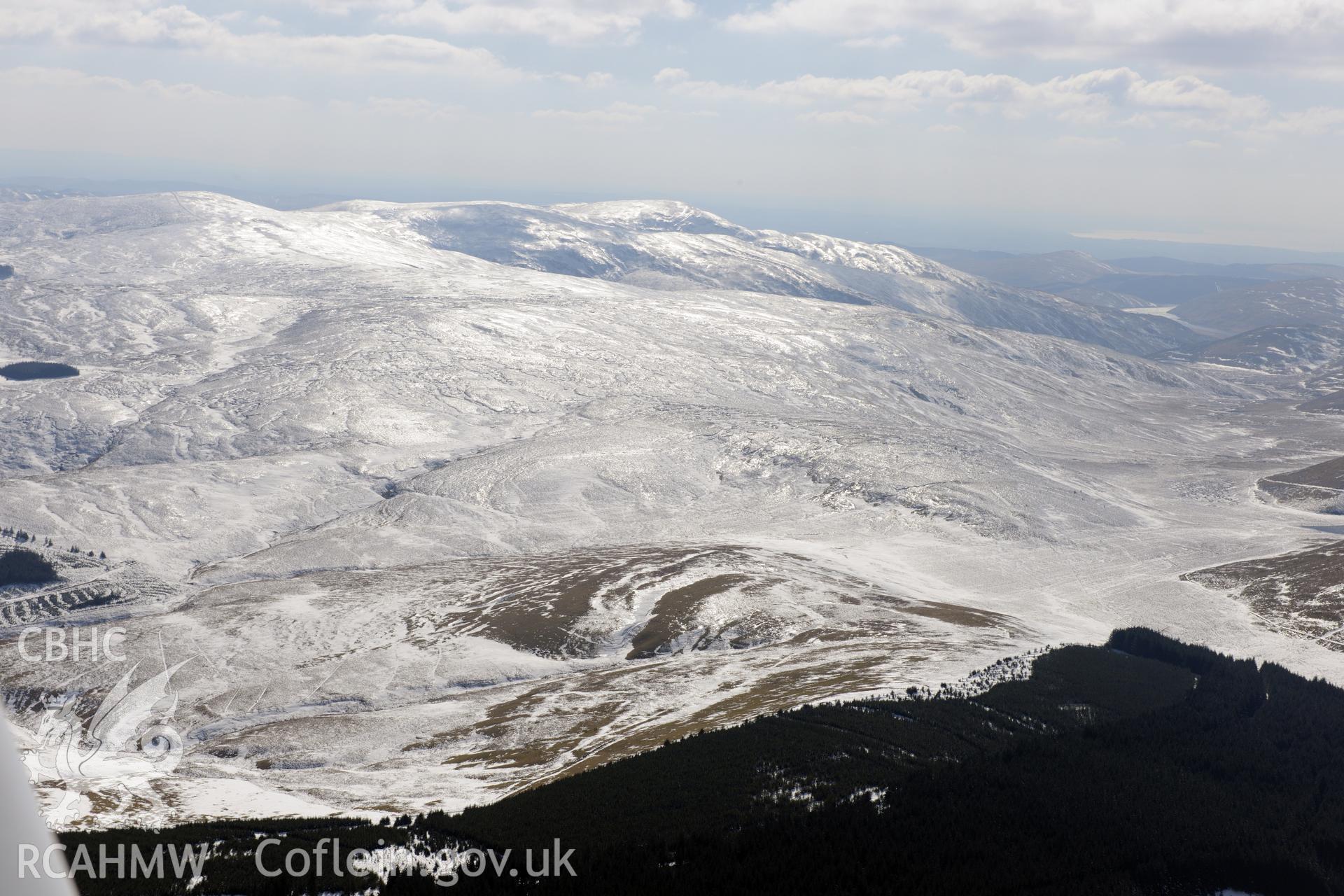 View from the north east of Pumlumon under ice. Oblique aerial photograph taken during the Royal Commission's programme of archaeological aerial reconnaissance by Toby Driver on 2nd April 2013.