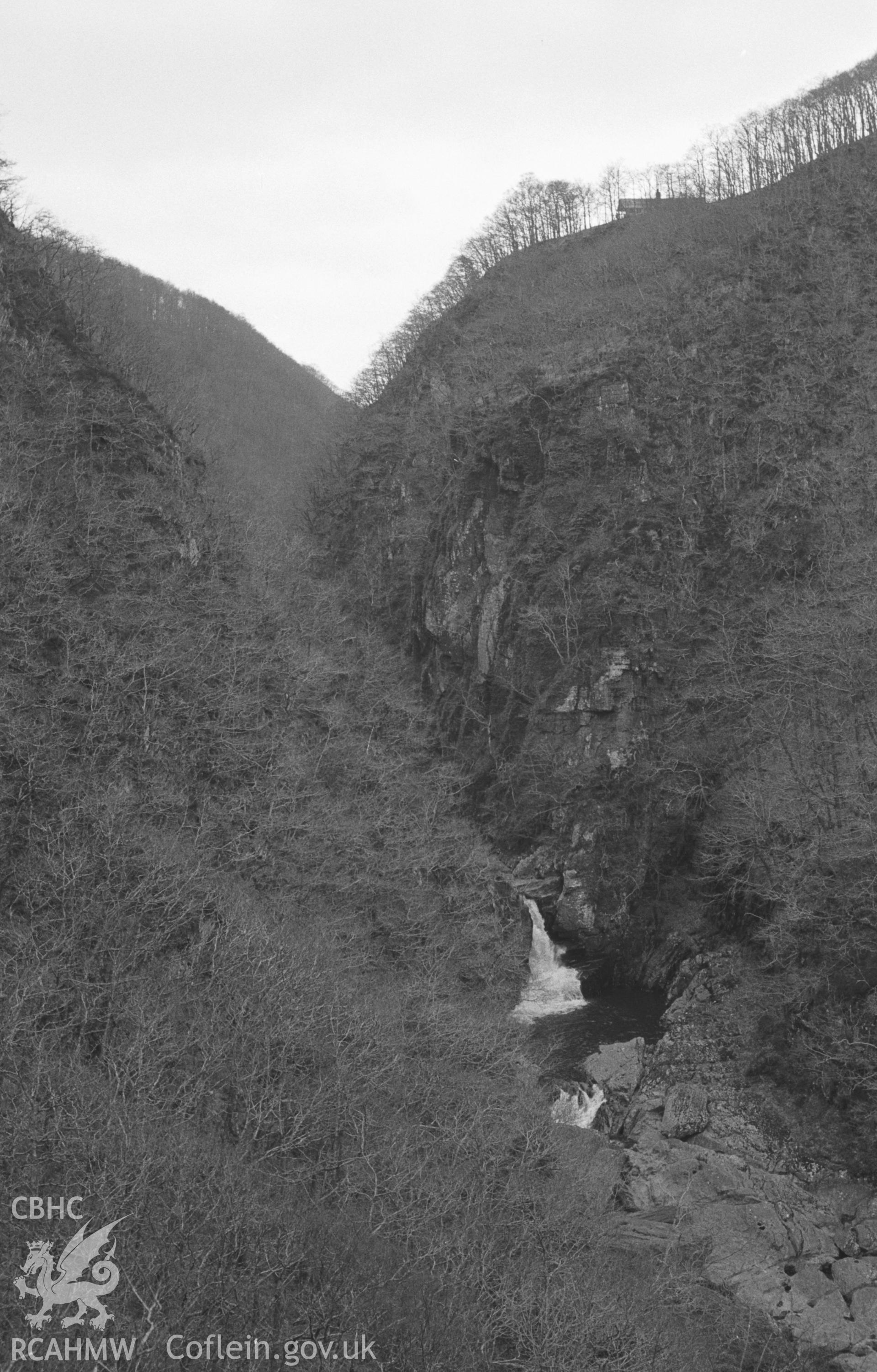 Digital copy of a black and white negative showing Cyfarllwyd Falls, Devils Bridge. Photographed by Arthur O. Chater in April 1966 from Grid Reference SN 742 774, looking north north east.