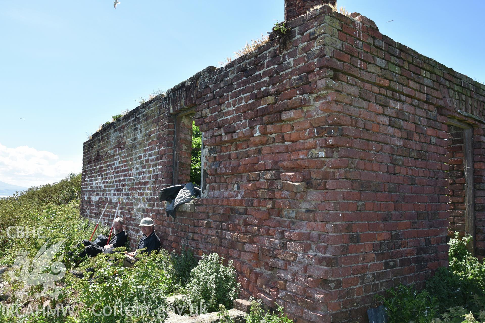 Investigator's photographic survey of the Telegraph Station on Puffin Island or Ynys Seiriol for the CHERISH Project. Exterior view of roofless building. ? Crown: CHERISH PROJECT 2018. Produced with EU funds through the Ireland Wales Co-operation Programme 2014-2020. All material made freely available through the Open Government Licence.