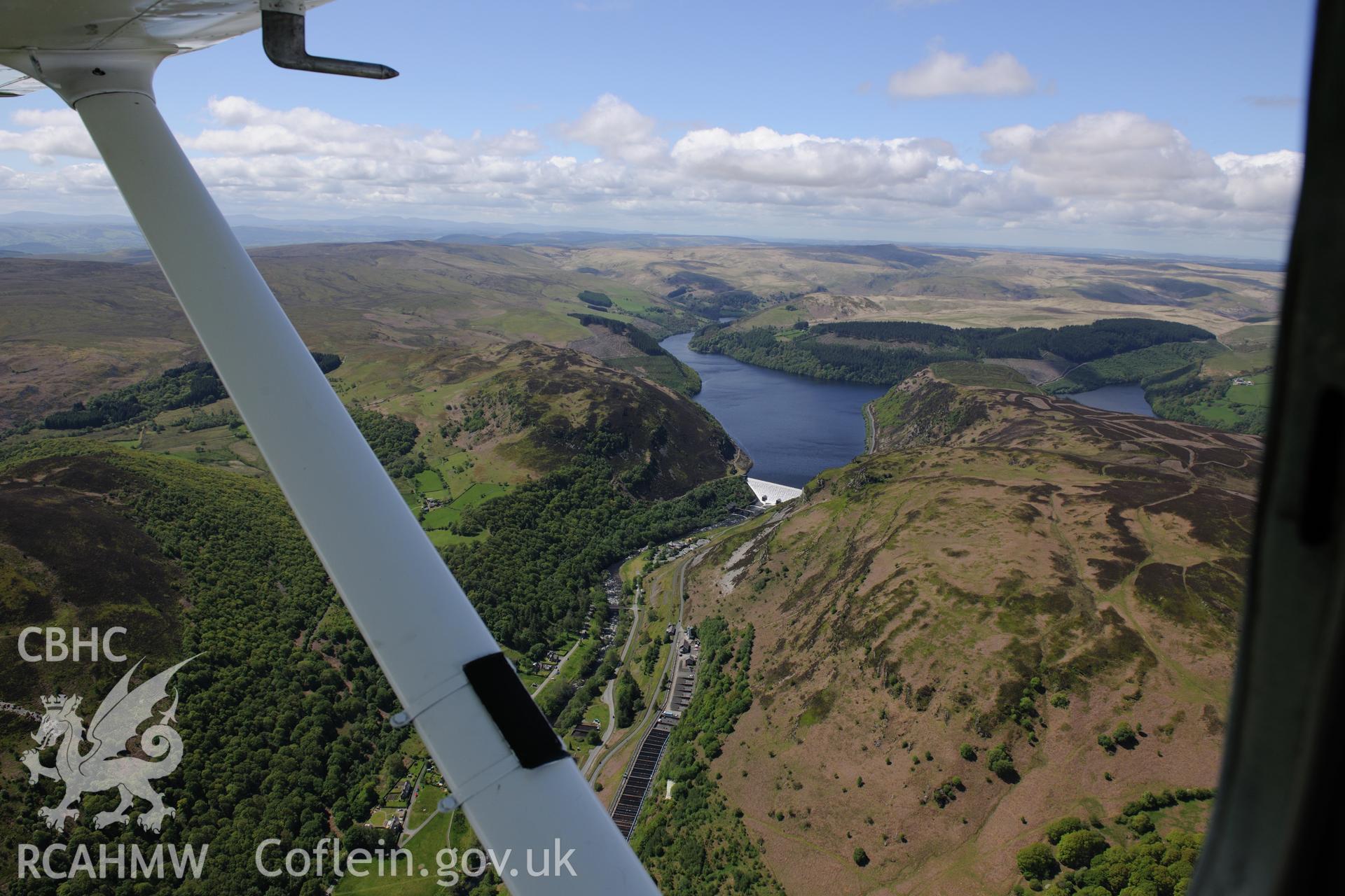 Landscape view of Caban Coch reservoir, dam and Elan Village, Birmingham Corporation Waterworks model village. Oblique aerial photograph taken during the Royal Commission?s programme of archaeological aerial reconnaissance by Toby Driver on 3rd June 2015.