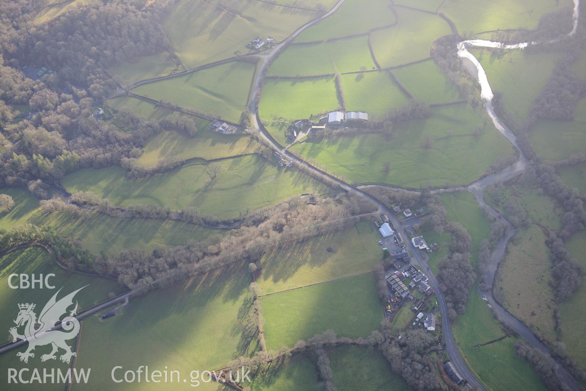 Pumpsaint, including views of Dolaucothi Lodge and stables; Dolaucothi Arms; Pumpsaint Post Office and Pumsaint Bridge. Oblique aerial photograph taken during the Royal Commission's programme of archaeological aerial reconnaissance by Toby Driver on 6th January 2015.