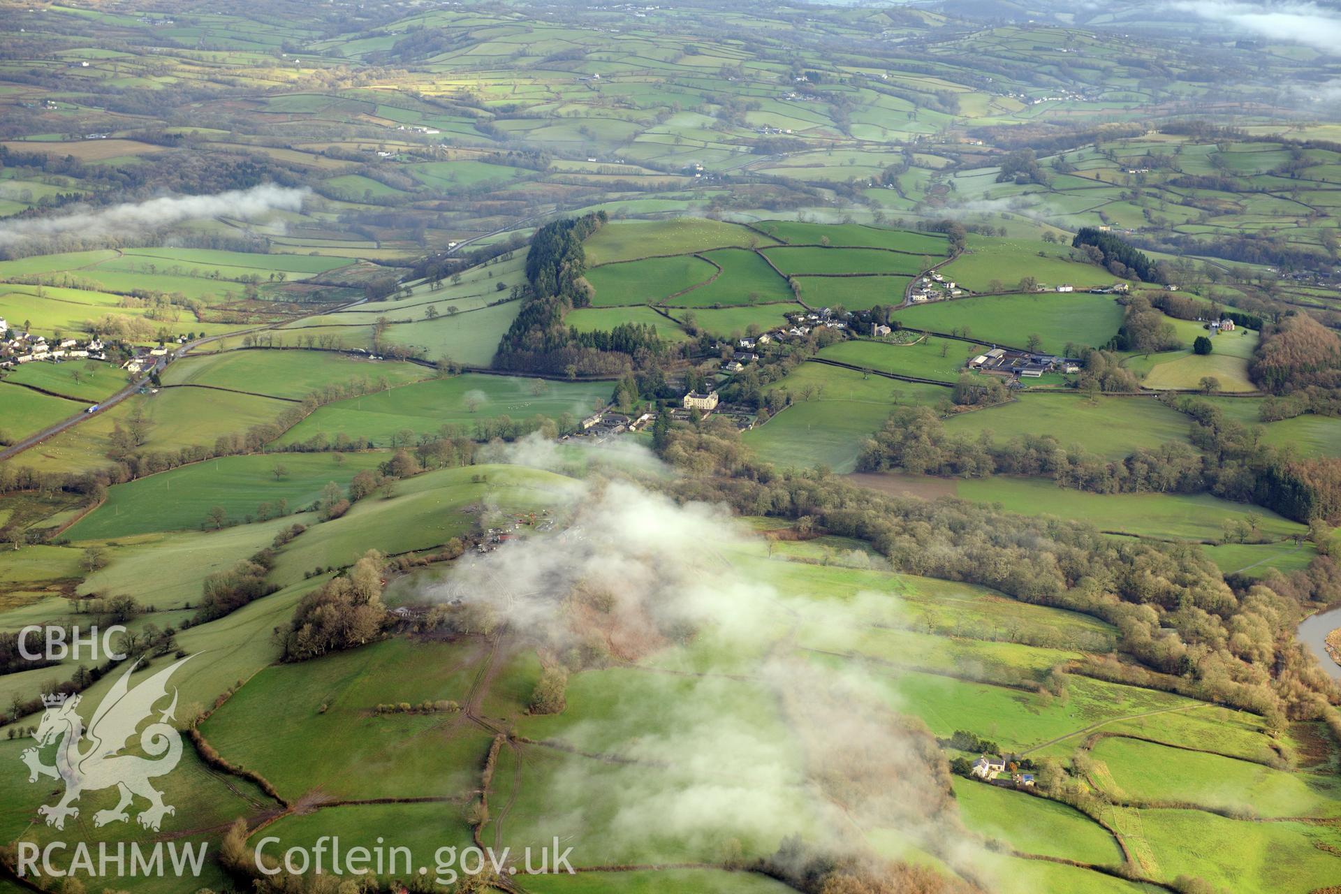 Aberglasney house, garden and south east courtyard range, with the village of Llangathen beyond. Oblique aerial photograph taken during the Royal Commission?s programme of archaeological aerial reconnaissance by Toby Driver on 15th January 2013.