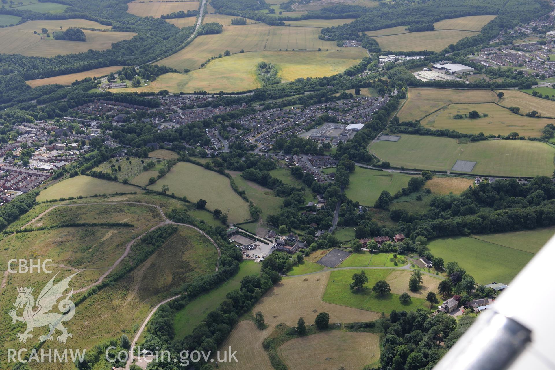 Rhiwabon town and the Tatham Bridge section of Offa's Dyke. Oblique aerial photograph taken during the Royal Commission's programme of archaeological aerial reconnaissance by Toby Driver on 30th July 2015.