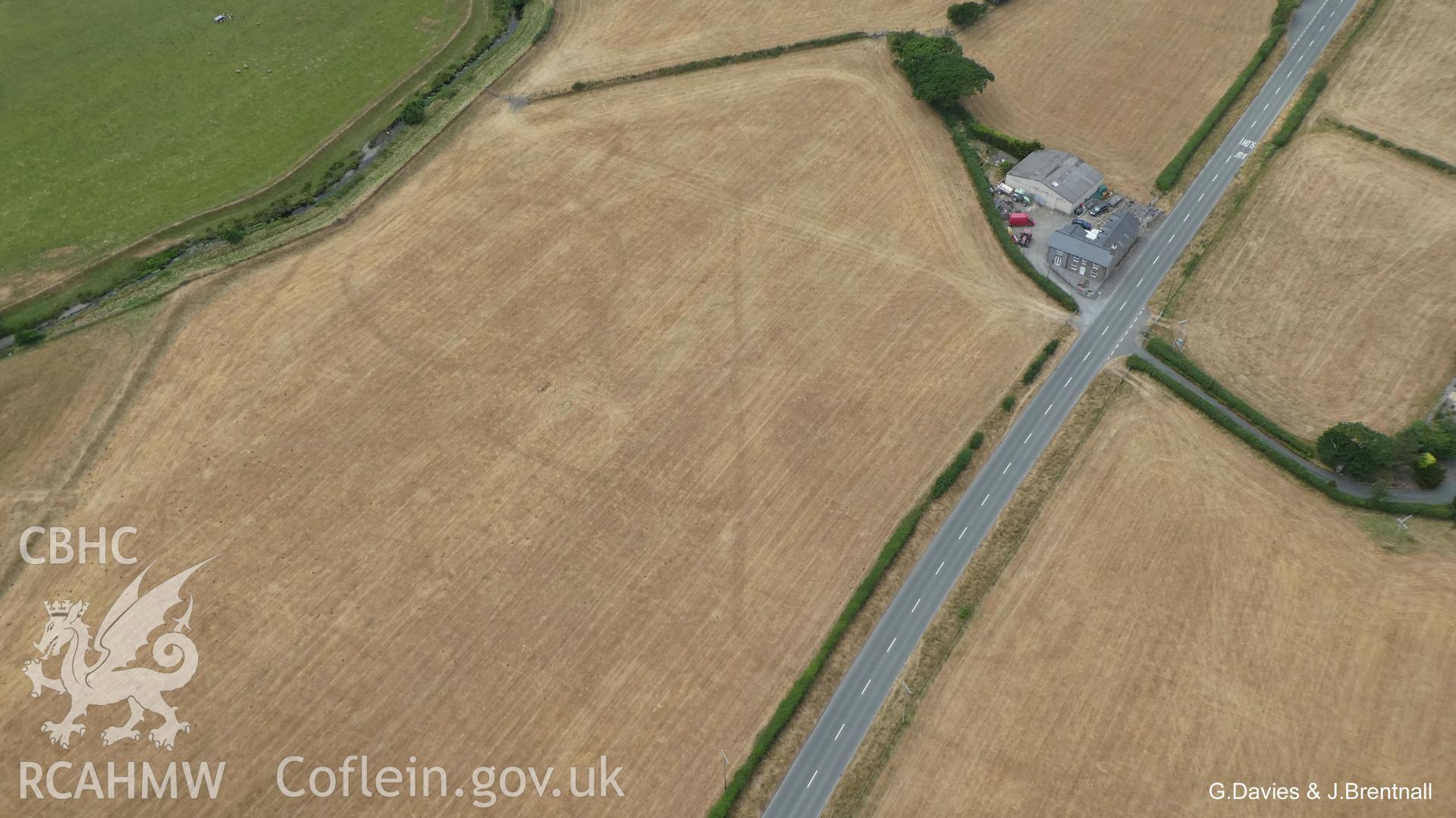 Aerial photograph of the Bryn-Crug cropmark complex, taken by Glyn Davies & Jonathan Brentnall under drought conditions, 15/07/2018. This photograph is the original, see BDC_01_01_03 for a modified version which enhances the visibility of the archaeology.