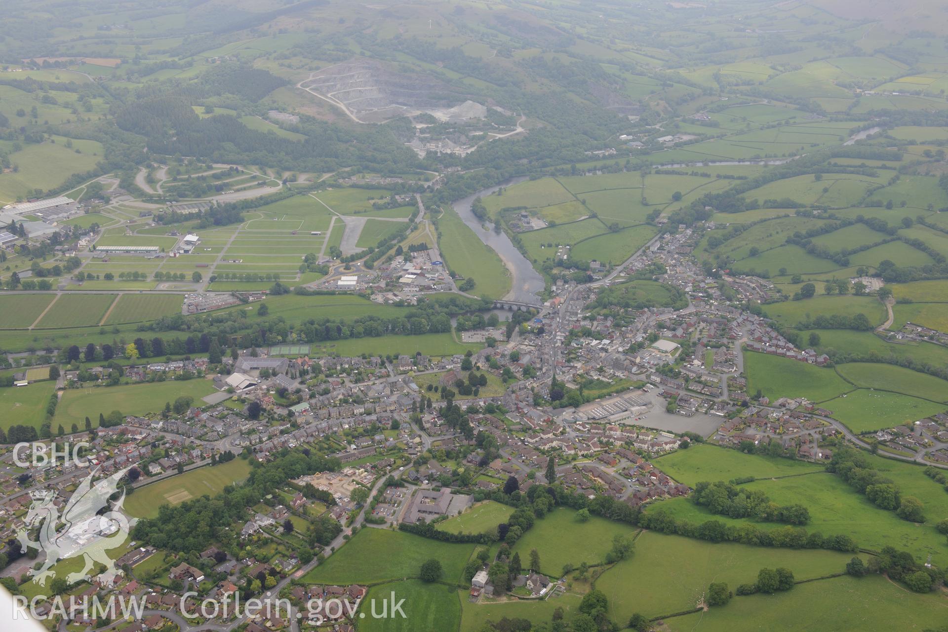 Builth Wells including castle, cattle market, Royal Welsh Showground, Llanelwedd stone quarry & bridge over Wye. Oblique aerial photograph taken during the Royal Commission's programme of archaeological aerial reconnaissance by Toby Driver on 11/6/2015.