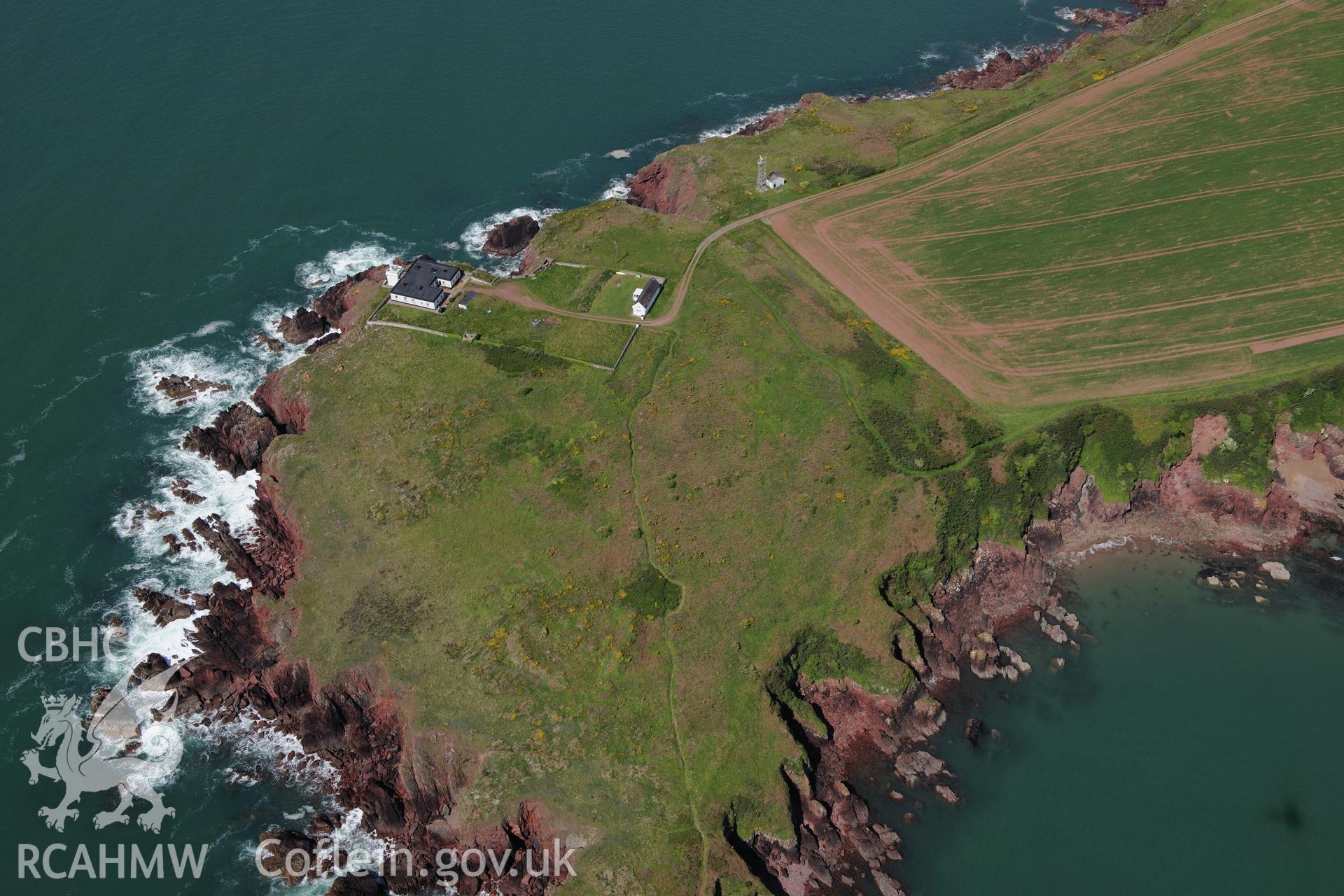 Great Castle Head promontory fort and Leading Lights, a summer house near St. Ishmaels. Oblique aerial photograph taken during the Royal Commission's programme of archaeological aerial reconnaissance by Toby Driver on 13th May 2015.