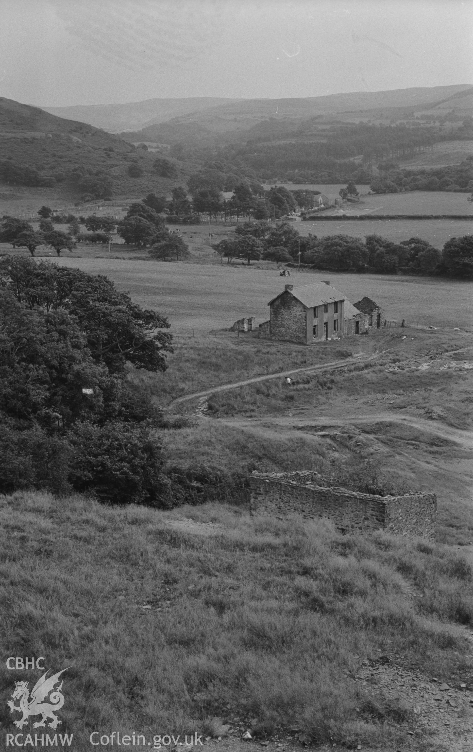 Digital copy of a black and white negative showing view looking over Abbey Consols mine to Strata Florida. Photographed by Arthur O. Chater on 25th August 1967, looking south south east from Grid Reference SN 743 662.