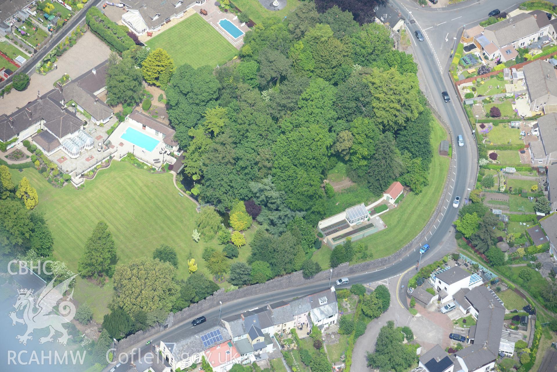 Caerleon town including views of the Roman barracks and Caerleon Castle. Oblique aerial photograph taken during the Royal Commission's programme of archaeological aerial reconnaissance by Toby Driver on 11th June 2015.