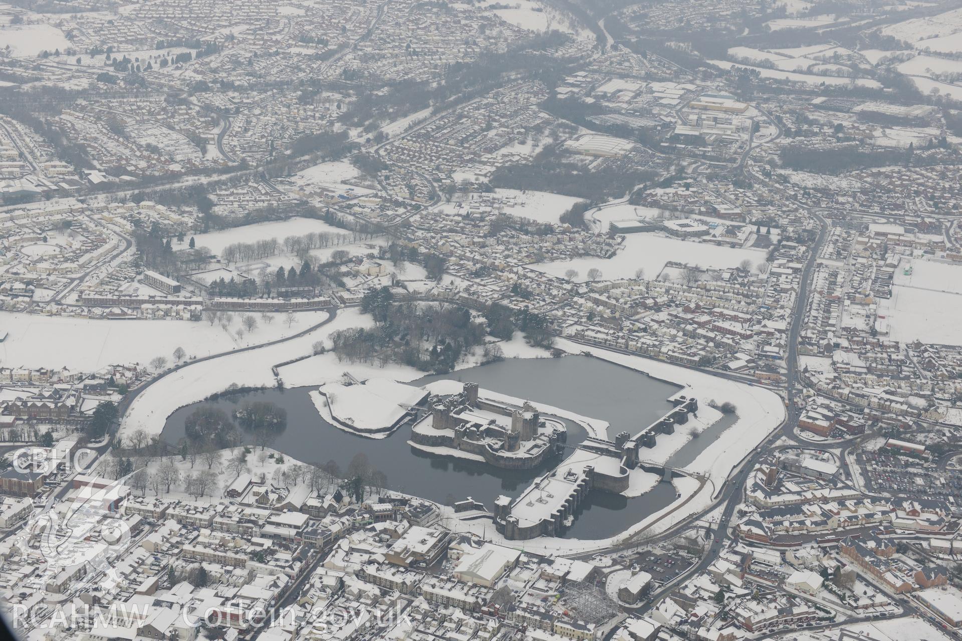 Caerphilly Castle and the town of Caerphilly. Oblique aerial photograph taken during the Royal Commission?s programme of archaeological aerial reconnaissance by Toby Driver on 24th January 2013.