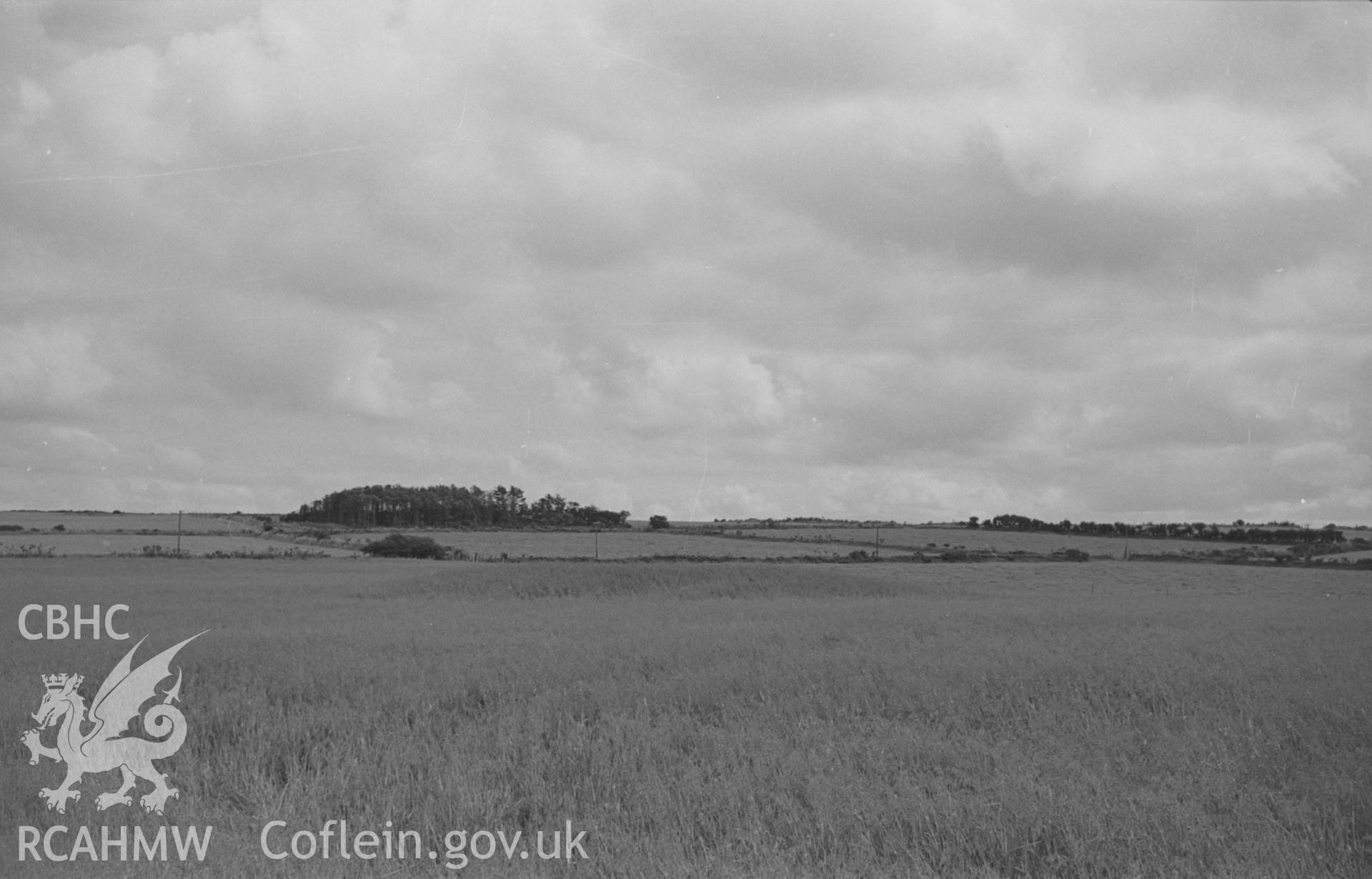 Digital copy of black & white negative showing distant view of Cwm Cou, remains of bronze-age tumulus in centre of cornfield, 1.7km south south east of Synod Inn. Photographed in August 1963 by Arthur O. Chater from Grid Ref SN 419 528, looking south east.