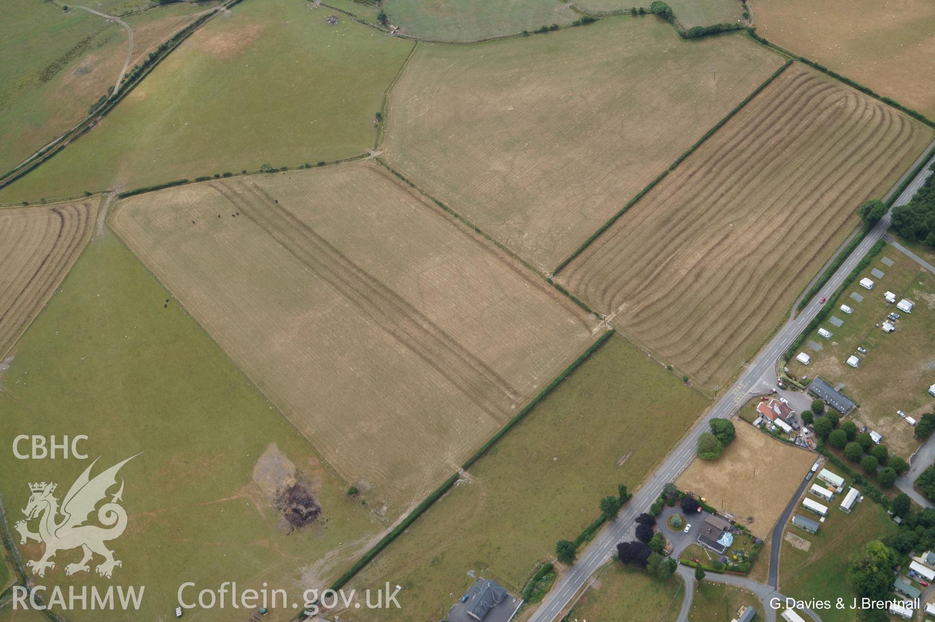 Aerial photograph of cropmarks south east of Ynysmaengwyn caravan park, taken by Glyn Davies & Jonathan Brentnall 16/07/2018 under drought conditions. Photograph is original. For modified version enhancing visibility of the archaeology, see: BDC_04_02_04.