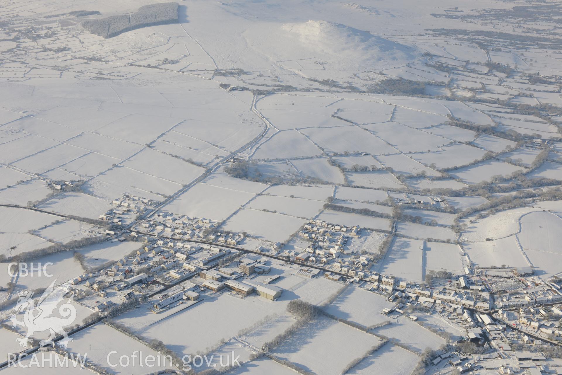 Foel Drygarn hillfort and the town of Crymych. Oblique aerial photograph taken during the Royal Commission?s programme of archaeological aerial reconnaissance by Toby Driver on 24th January 2013.