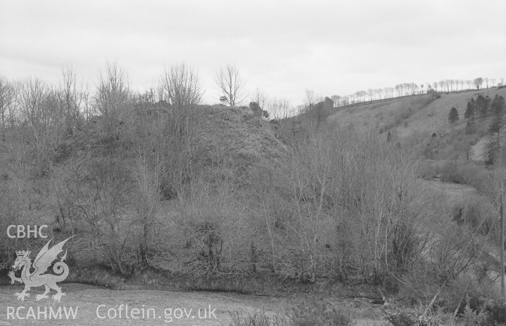 Digital copy of a black and white negative showing Castell Hywel motte, west of Lampeter. Photographed by Arthur O. Chater in April 1965 from Grid Reference SN 4405 4773, looking south. (Panorama 1 of 2 photographs)