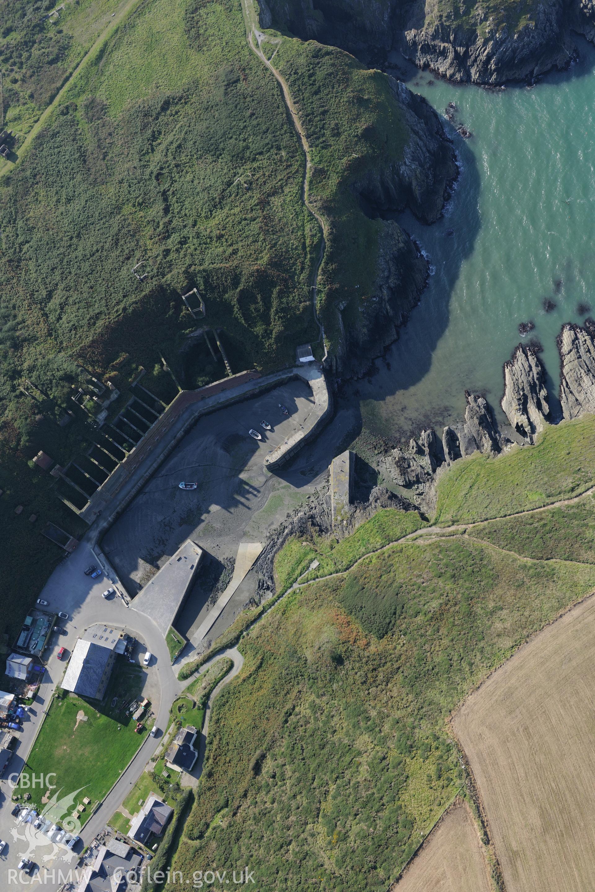 Remains of Porthgain quarry including the harbour and brickworks. Oblique aerial photograph taken during the Royal Commission's programme of archaeological aerial reconnaissance by Toby Driver on 30th September 2015.