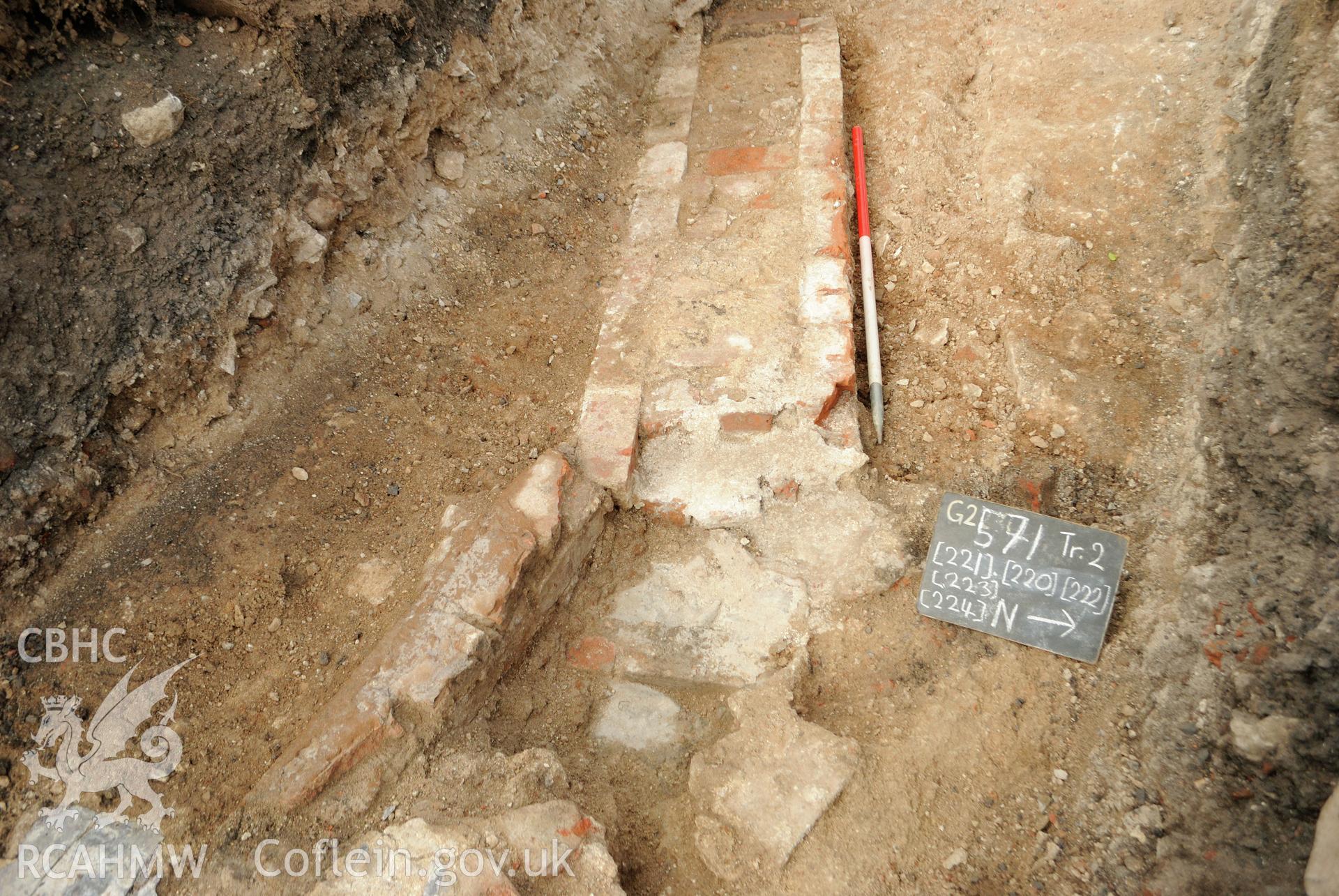 View from east north east of 2 brick walled features; slate/brick outflow level; dislodged slate & rubble deposit. Photographed during archaeological evaluation of Kinmel Park, Abergele, by Gwynedd Archaeological Trust, 24/08/2018. Project no. 2571.