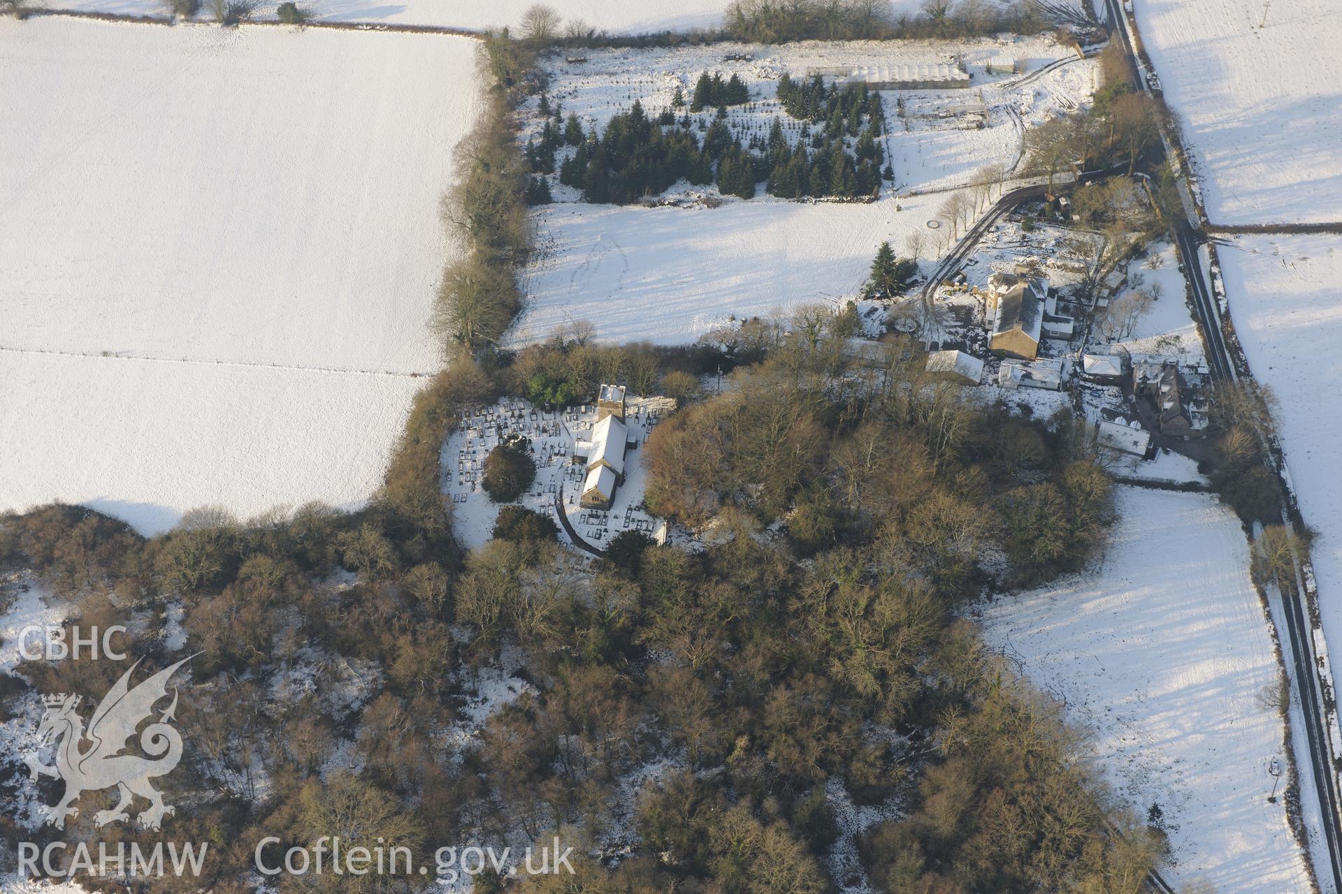 St. Illtyd's Church and Llanilid Castle ring-work, Llanharan, east of Bridgend. Oblique aerial photograph taken during the Royal Commission?s programme of archaeological aerial reconnaissance by Toby Driver on 24th January 2013.