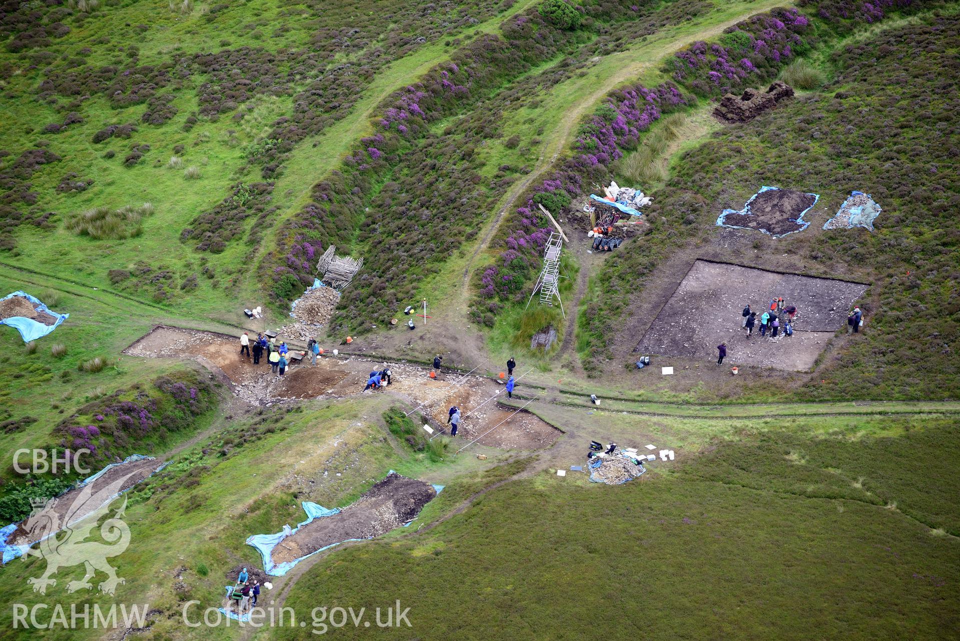 Penycloddiau Hilfort and Hut Platform V, Llangwyfan. Excavation by Liverpool University. Oblique aerial photograph taken during the Royal Commission's programme of archaeological aerial reconnaissance by Toby Driver on 30th July 2015.