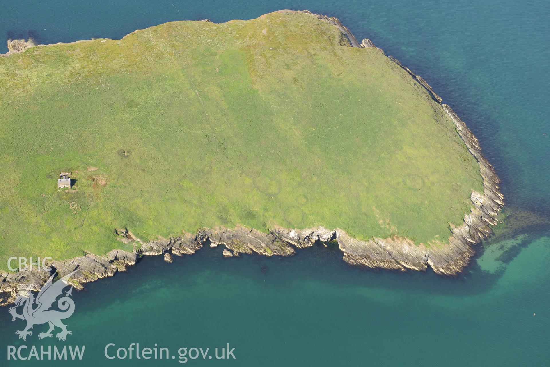 The chapel building, the footings of a priory hall and the fish trap at St. Tudwal's Island East. Oblique aerial photograph taken during the Royal Commission's programme of archaeological aerial reconnaissance by Toby Driver on 23rd June 2015.