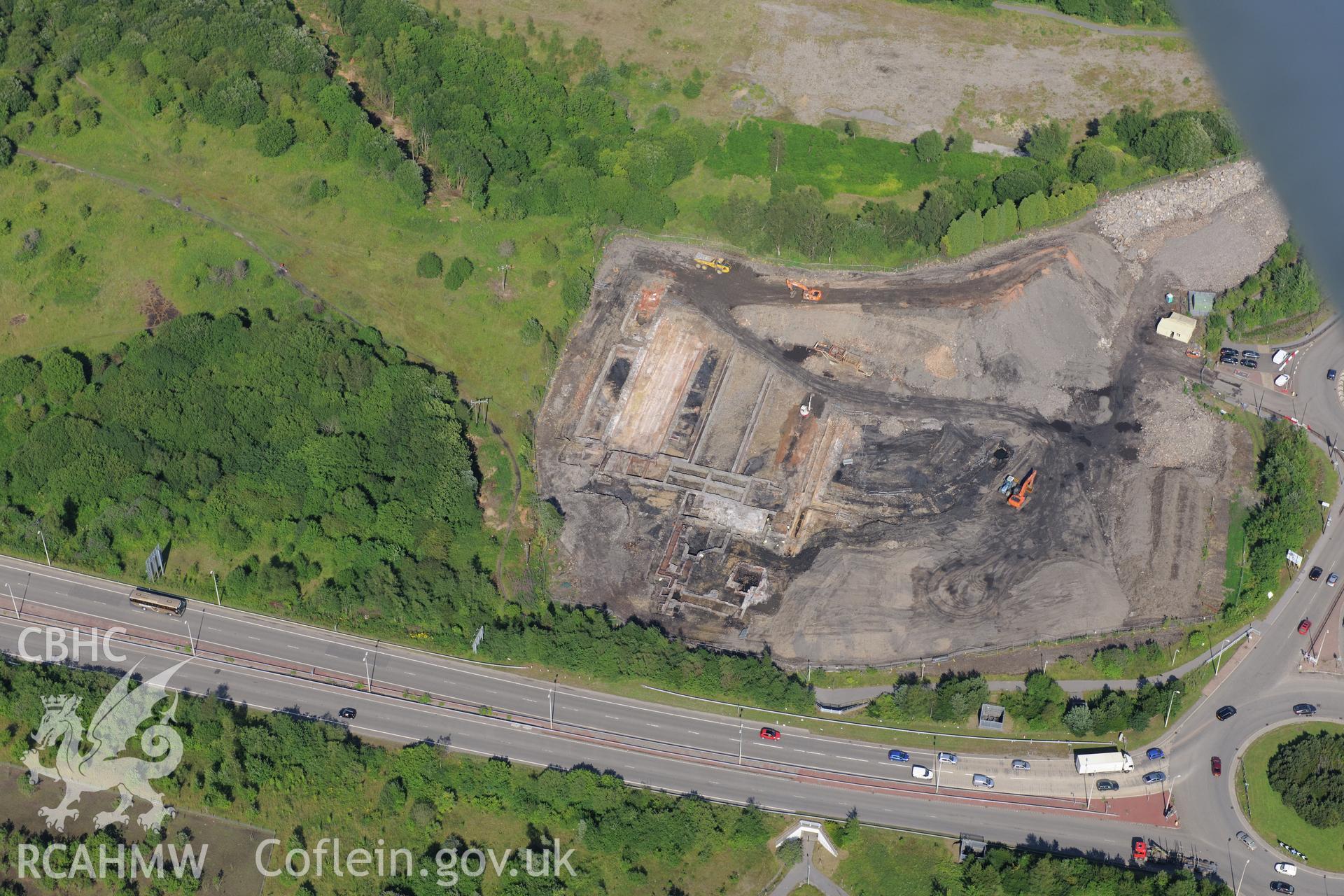 Site of former Rotax factory, Cyfarthfa Retail Park, and Cyfarthfa Ironworks including the remains of its blast furnaces, under excavation by Glamorgan-Gwent Archaeological Trust. Oblique aerial photograph taken during the Royal Commission?s programme of