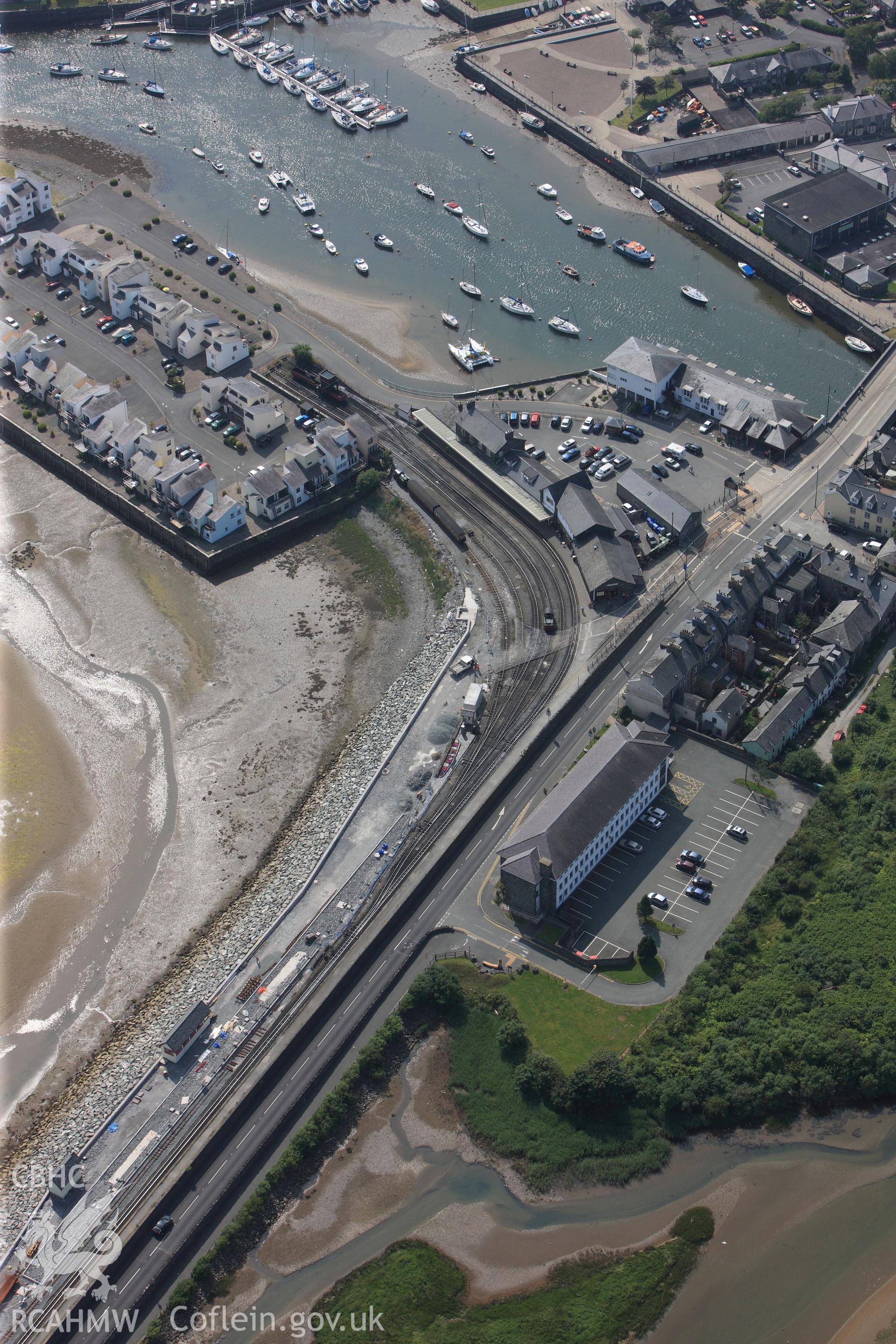 Porthmadog harbour and associated new Snowdon Wharf and railway station, Porthmadog. Oblique aerial photograph taken during the Royal Commission?s programme of archaeological aerial reconnaissance by Toby Driver on 12th July 2013.