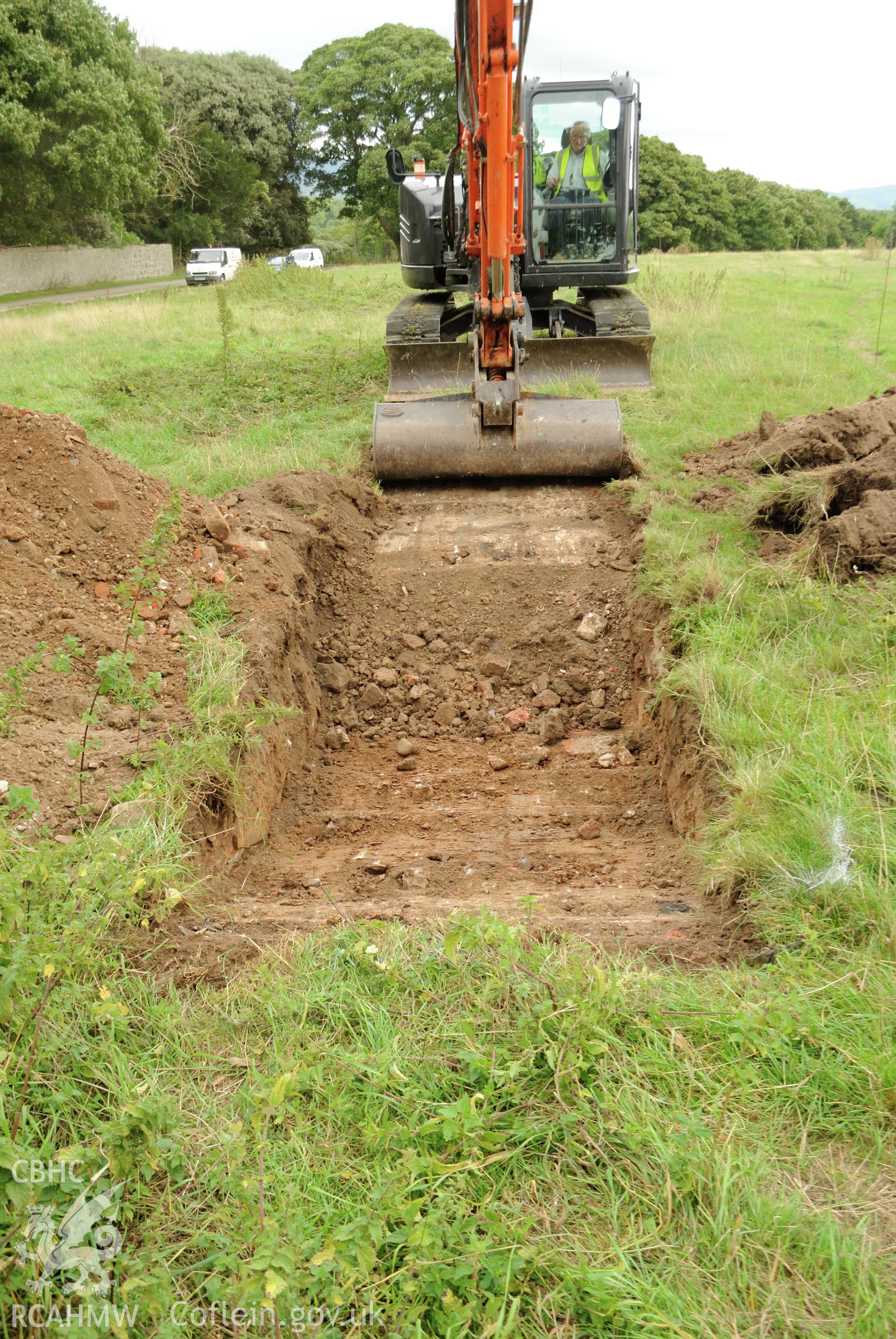 View from west showing excavation of trench 1. Photographed during archaeological evaluation of Kinmel Park, Abergele, conducted by Gwynedd Archaeological Trust on 22nd August 2018. Project no. 2571.