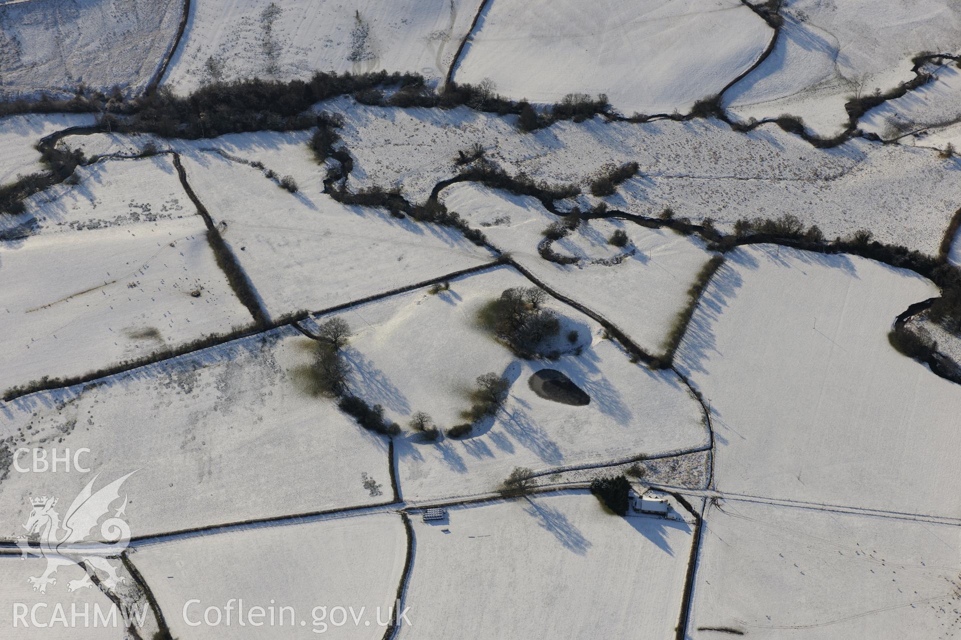 The Mount motte and bailey, Glascwm, north east of Builth Wells. Oblique aerial photograph taken during the Royal Commission?s programme of archaeological aerial reconnaissance by Toby Driver on 15th January 2013.