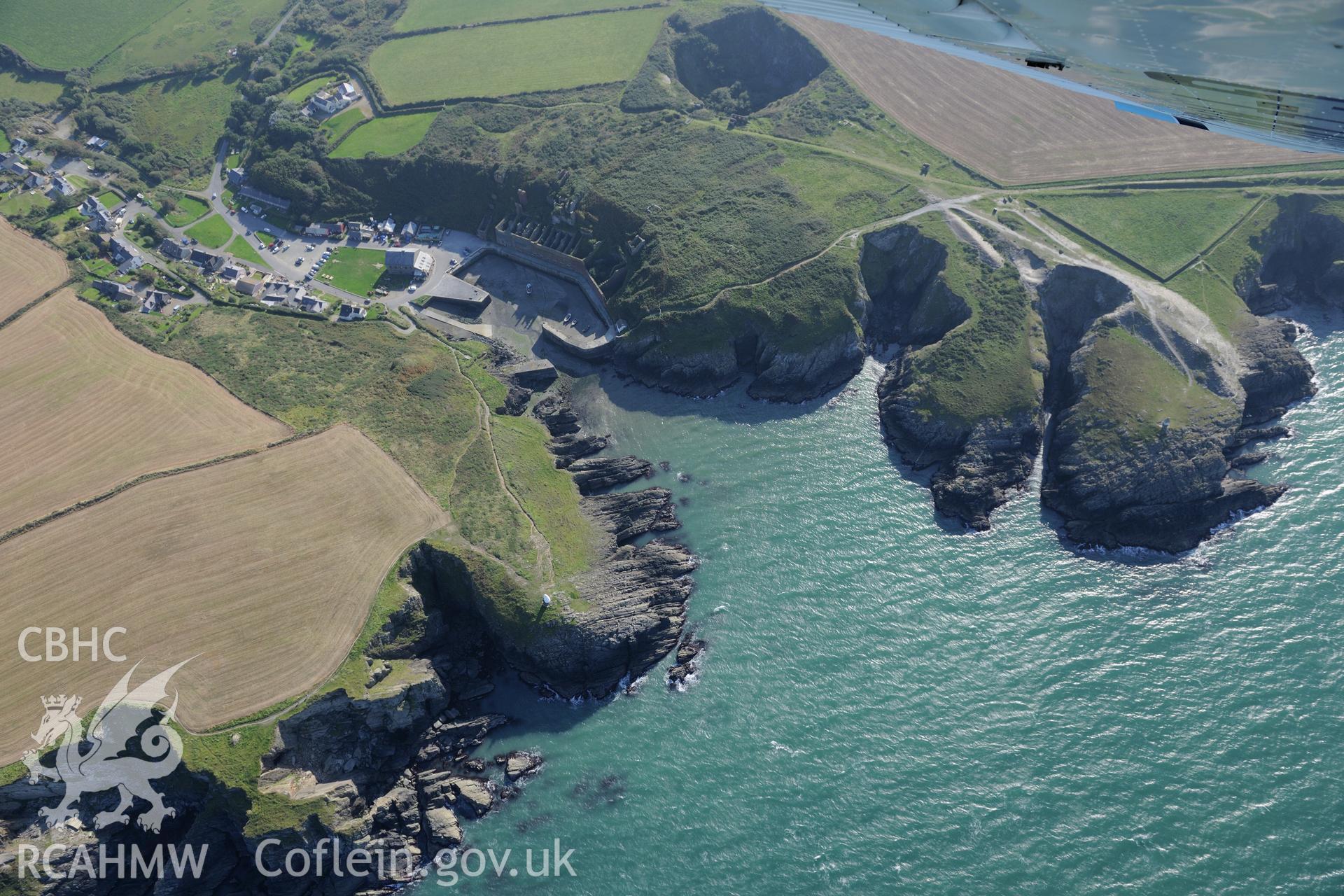 Remains of Porthgain quarry including the harbour and brickworks. Oblique aerial photograph taken during the Royal Commission's programme of archaeological aerial reconnaissance by Toby Driver on 30th September 2015.