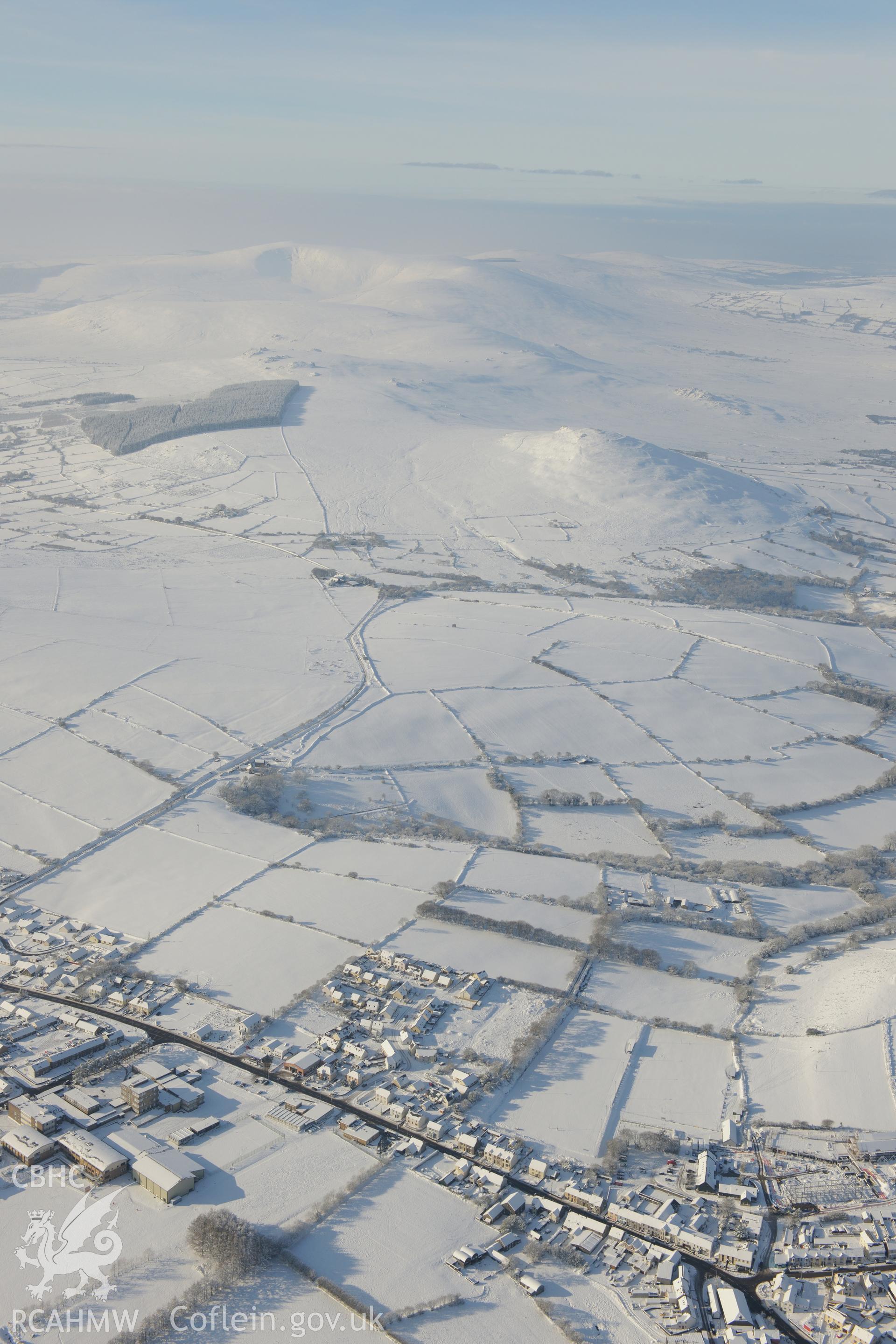 Foel Drygarn hillfort and the town of Crymych. Oblique aerial photograph taken during the Royal Commission?s programme of archaeological aerial reconnaissance by Toby Driver on 24th January 2013.