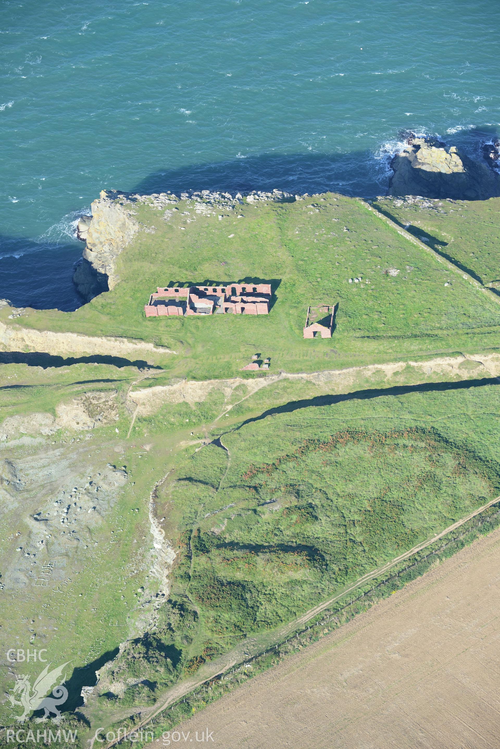 Remains of Porthgain stone quarry, including the offices and stores. Oblique aerial photograph taken during the Royal Commission's programme of archaeological aerial reconnaissance by Toby Driver on 30th September 2015.