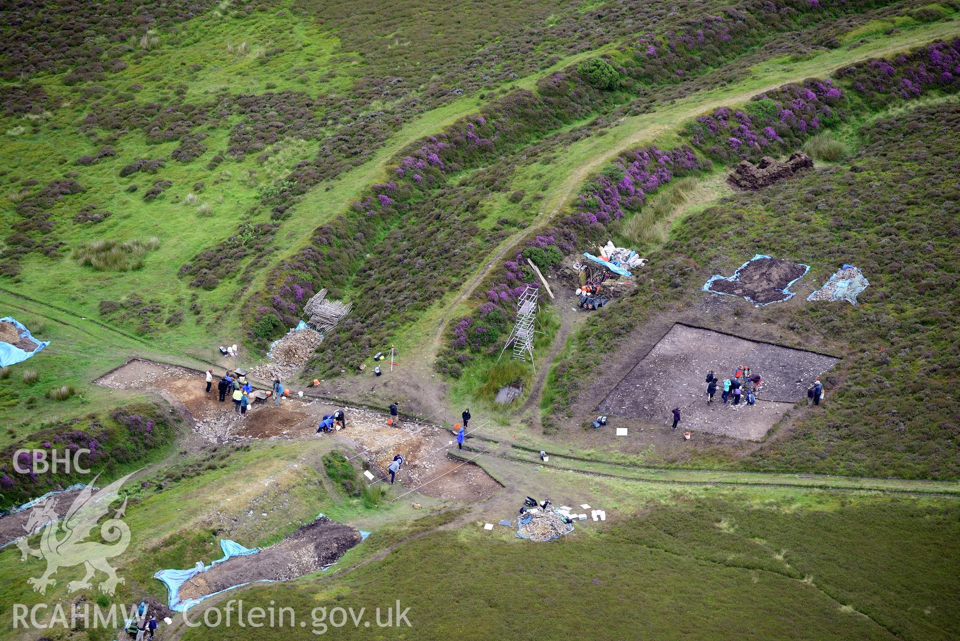 Penycloddiau Hilfort and Hut Platform V, Llangwyfan. Excavation by Liverpool University. Oblique aerial photograph taken during the Royal Commission's programme of archaeological aerial reconnaissance by Toby Driver on 30th July 2015.