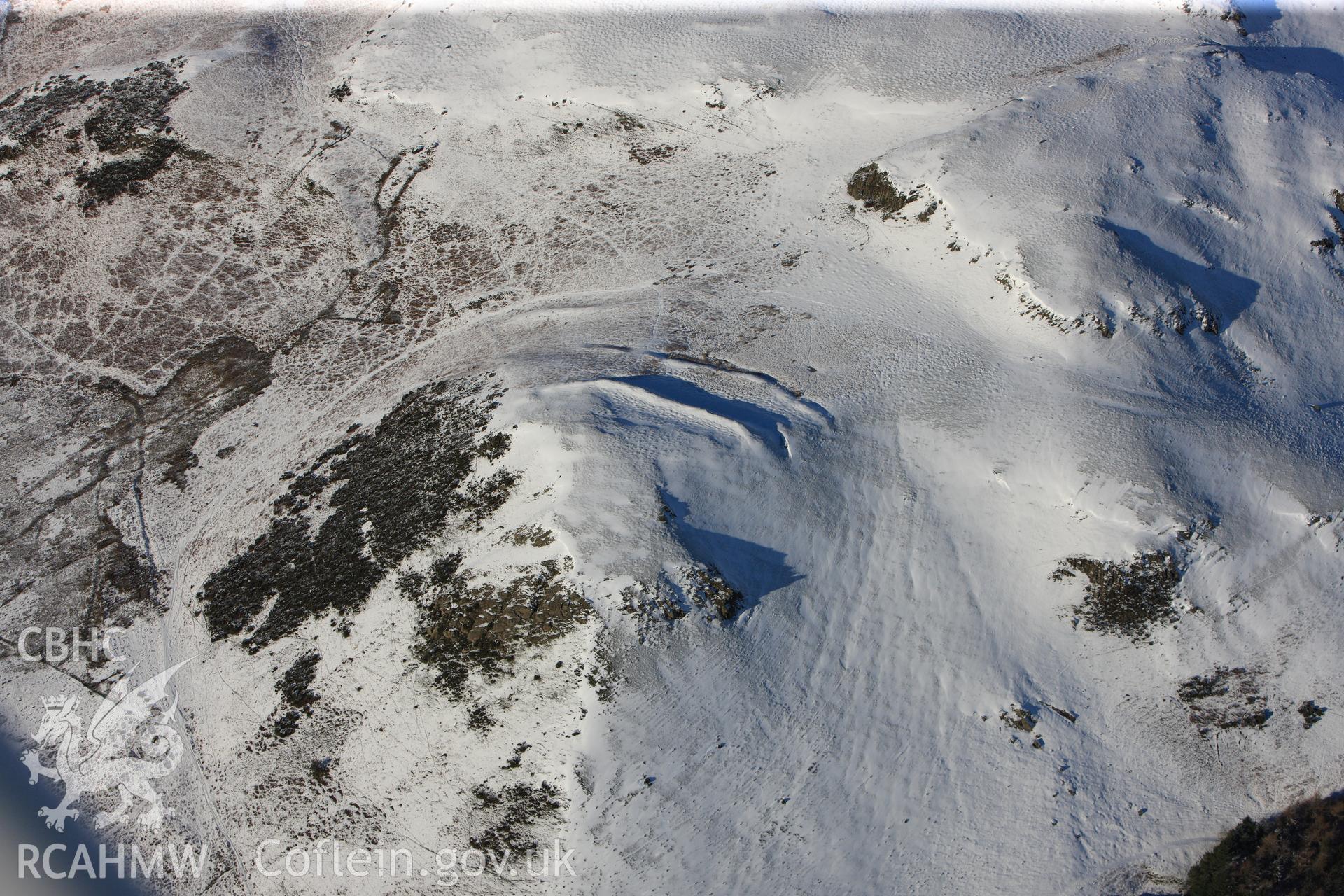 Cwm Berwyn defended enclosure and hut platform, Glascwm, north east of Builth Wells. Oblique aerial photograph taken during the Royal Commission?s programme of archaeological aerial reconnaissance by Toby Driver on 15th January 2013.