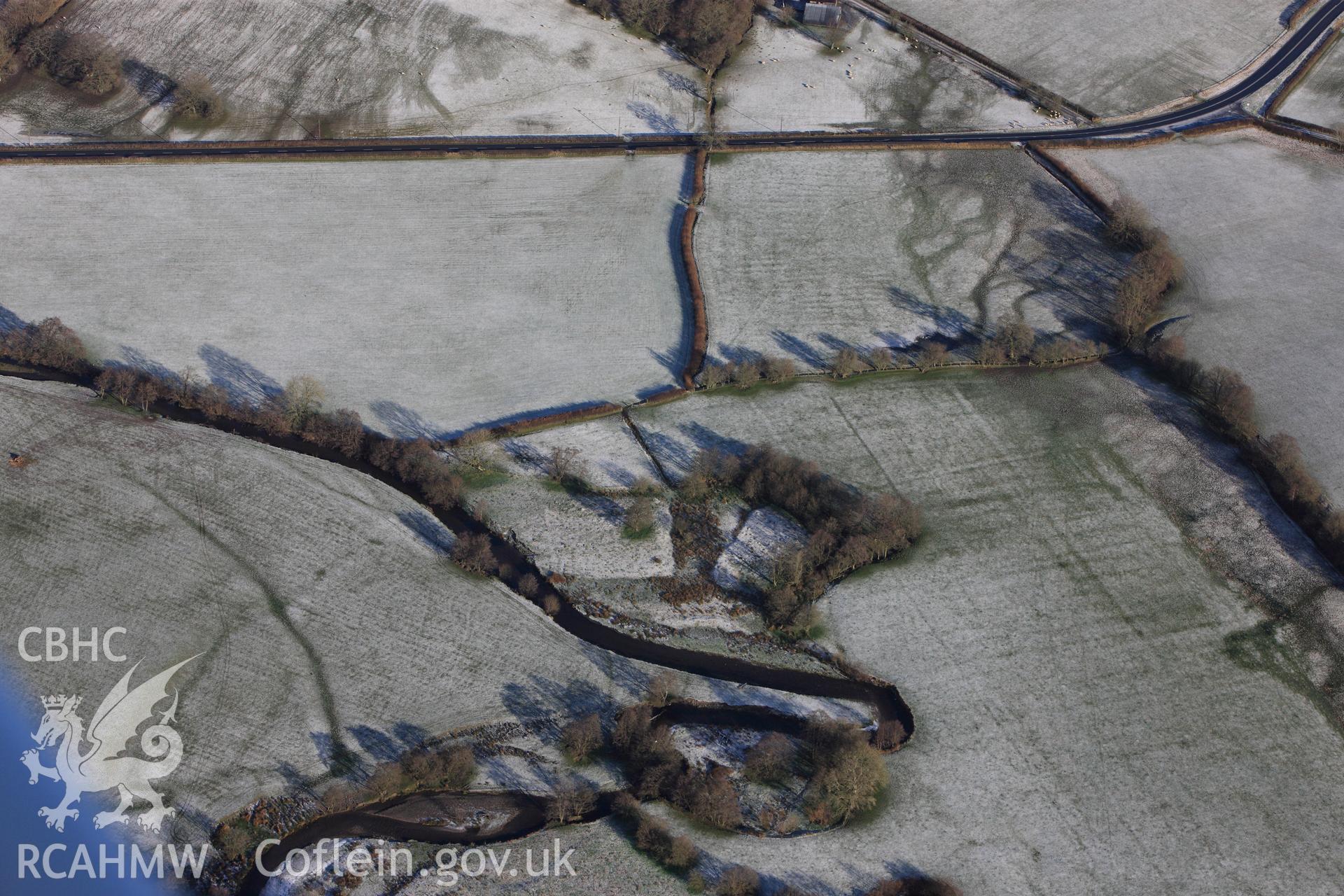 Riverside earthworks to the south-east of Caerau Roman Fort, Beulah, west of Builth Wells. Oblique aerial photograph taken during the Royal Commission?s programme of archaeological aerial reconnaissance by Toby Driver on 15th January 2013.