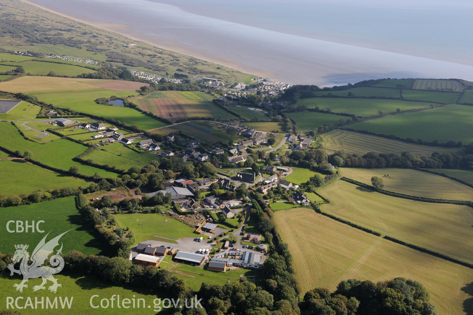 St. Margaret Marlos church in the heart of Pendine, near Laugharne, on the south coast of Wales. Oblique aerial photograph taken during the Royal Commission's programme of archaeological aerial reconnaissance by Toby Driver on 30th September 2015.