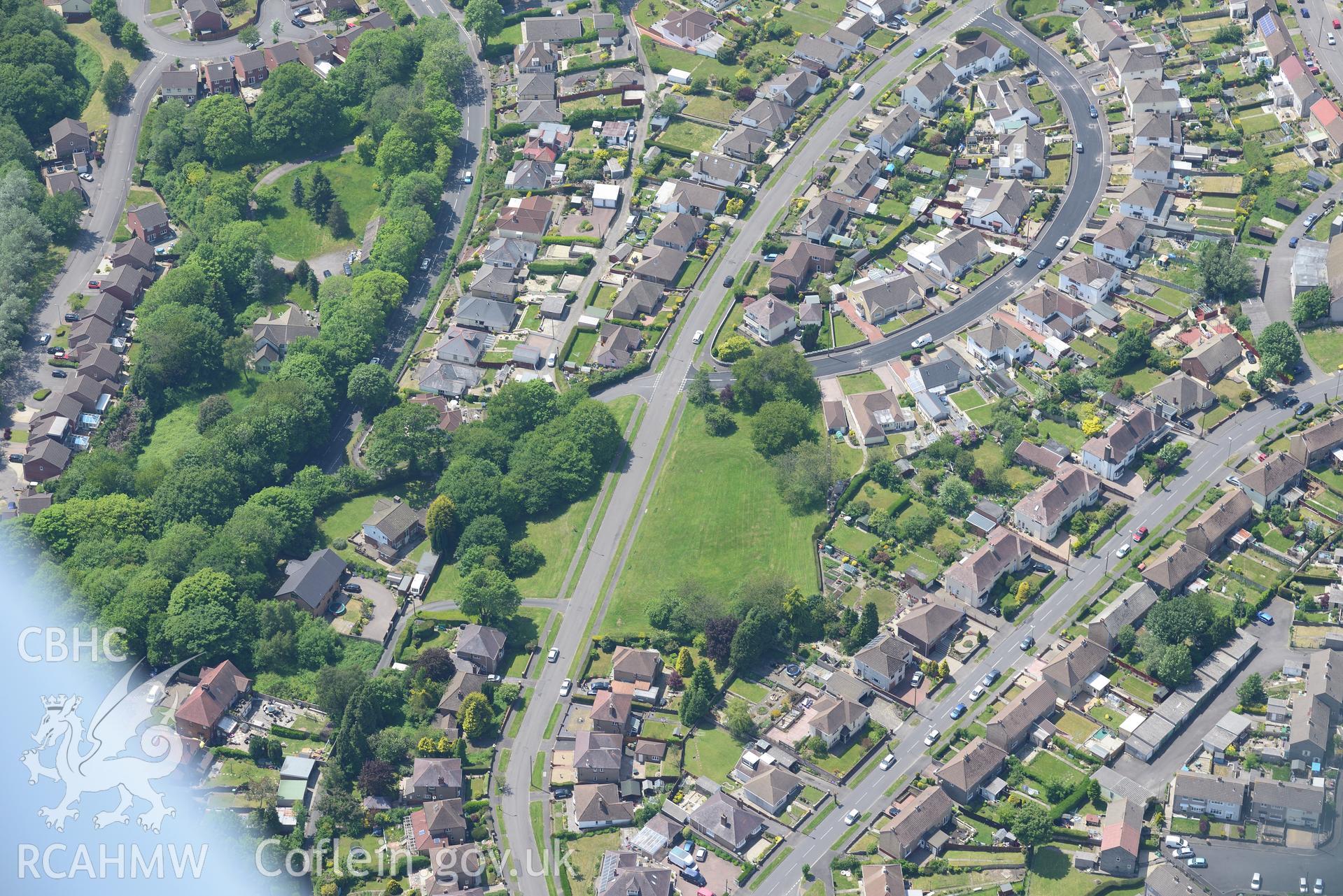 Pontllanfraith village, with Penllwyn Fawr enclosure at it's centre. Oblique aerial photograph taken during the Royal Commission's programme of archaeological aerial reconnaissance by Toby Driver on 11th June 2015.