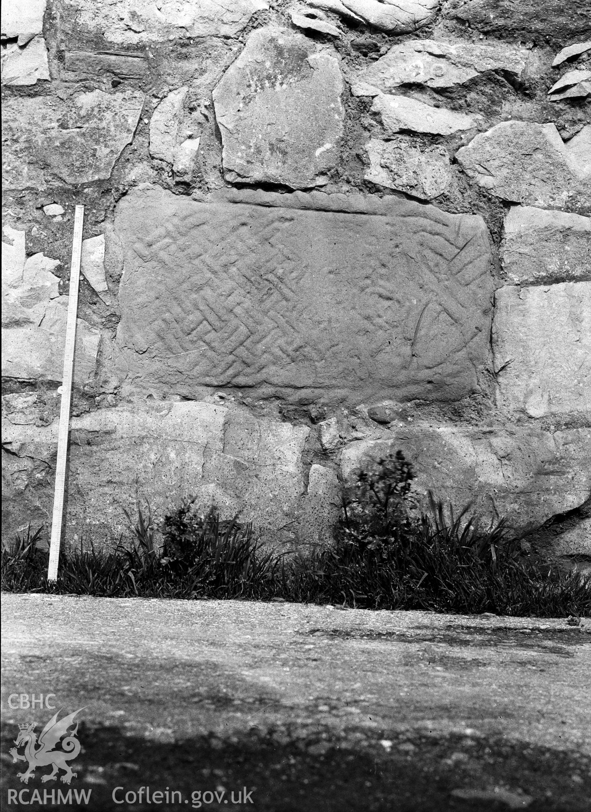 Digital copy of a nitrate negative showing view of inscribed stones in vicarage wall at the Friary near Rhuddlan Church, taken by Leonard Monroe.