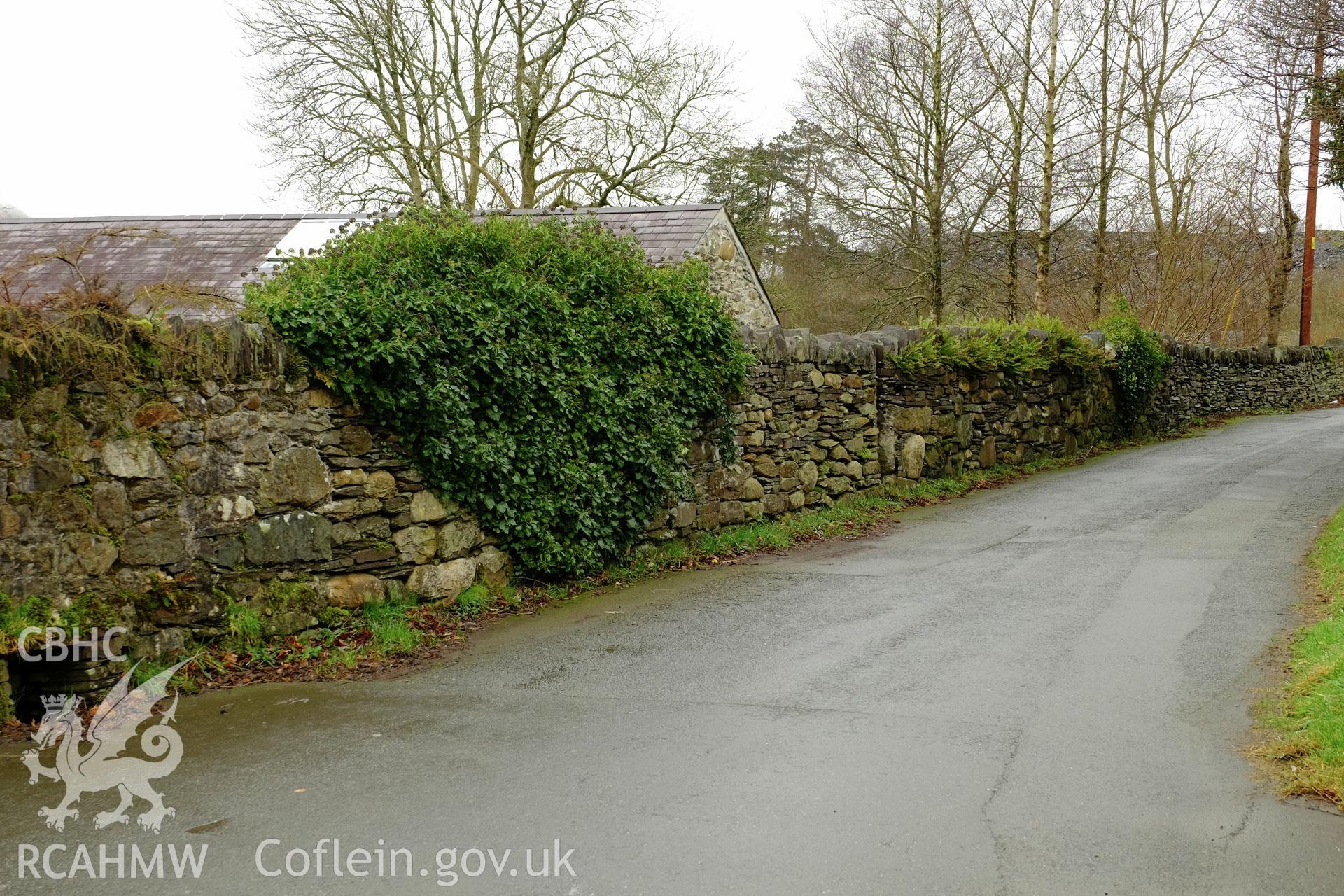 Colour photograph showing view looking west at a roadside wall opposite Tai Nantlle, Nantlle produced by Richard Hayman 9th February 2017