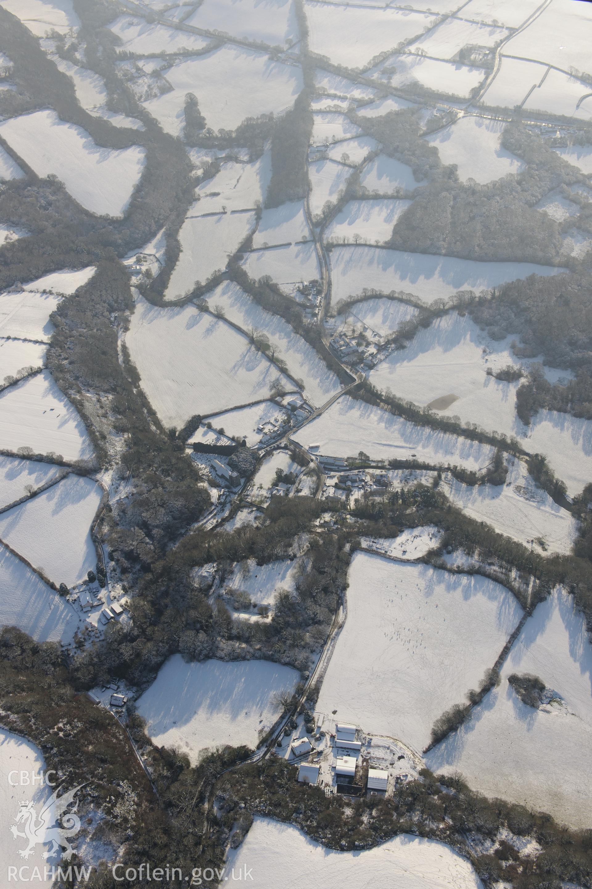 Nevern castle and the surrounding town, between Cardigan and Fishguard. Oblique aerial photograph taken during the Royal Commission?s programme of archaeological aerial reconnaissance by Toby Driver on 24th January 2013.