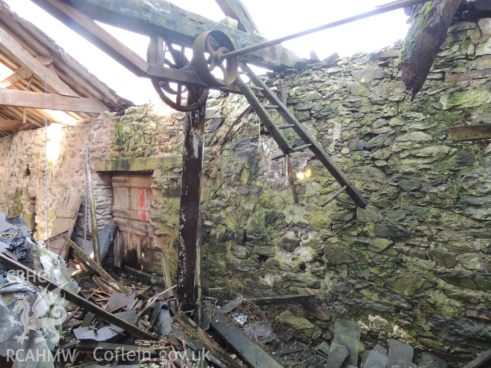 Remains of threshing machine, looking north east. Photograph taken as part of archaeological building survey conducted at Bryn Gwylan Threshing Barn, Llangernyw, Conwy, carried out by Archaeology Wales, 2017-2018. Report no. 1640. Project no. 2578.