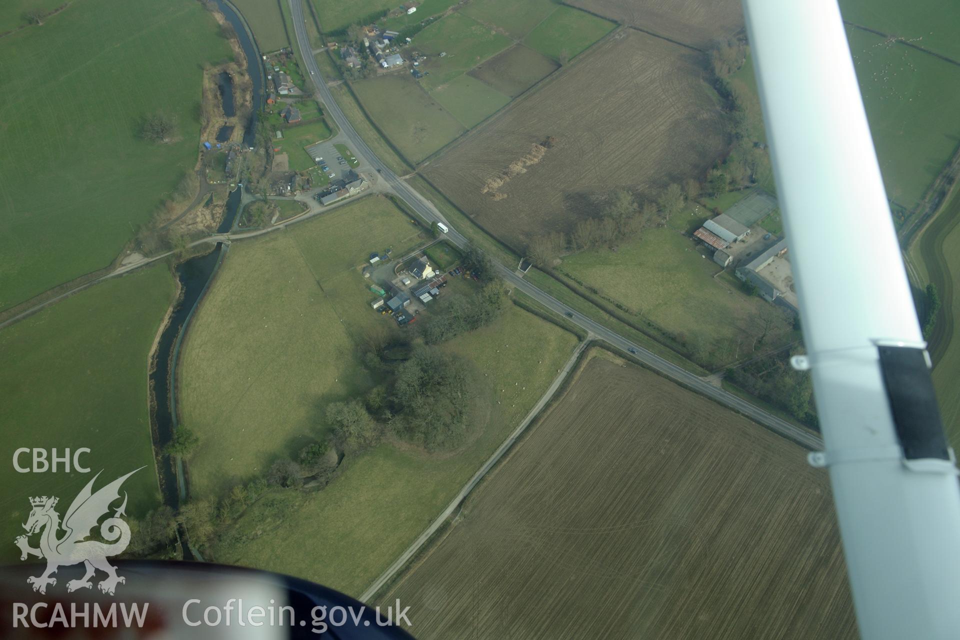 Upper Luggy motte and bailey castle, north east of Berriew. Oblique aerial photograph taken during the Royal Commission?s programme of archaeological aerial reconnaissance by Toby Driver on 28th February 2013.