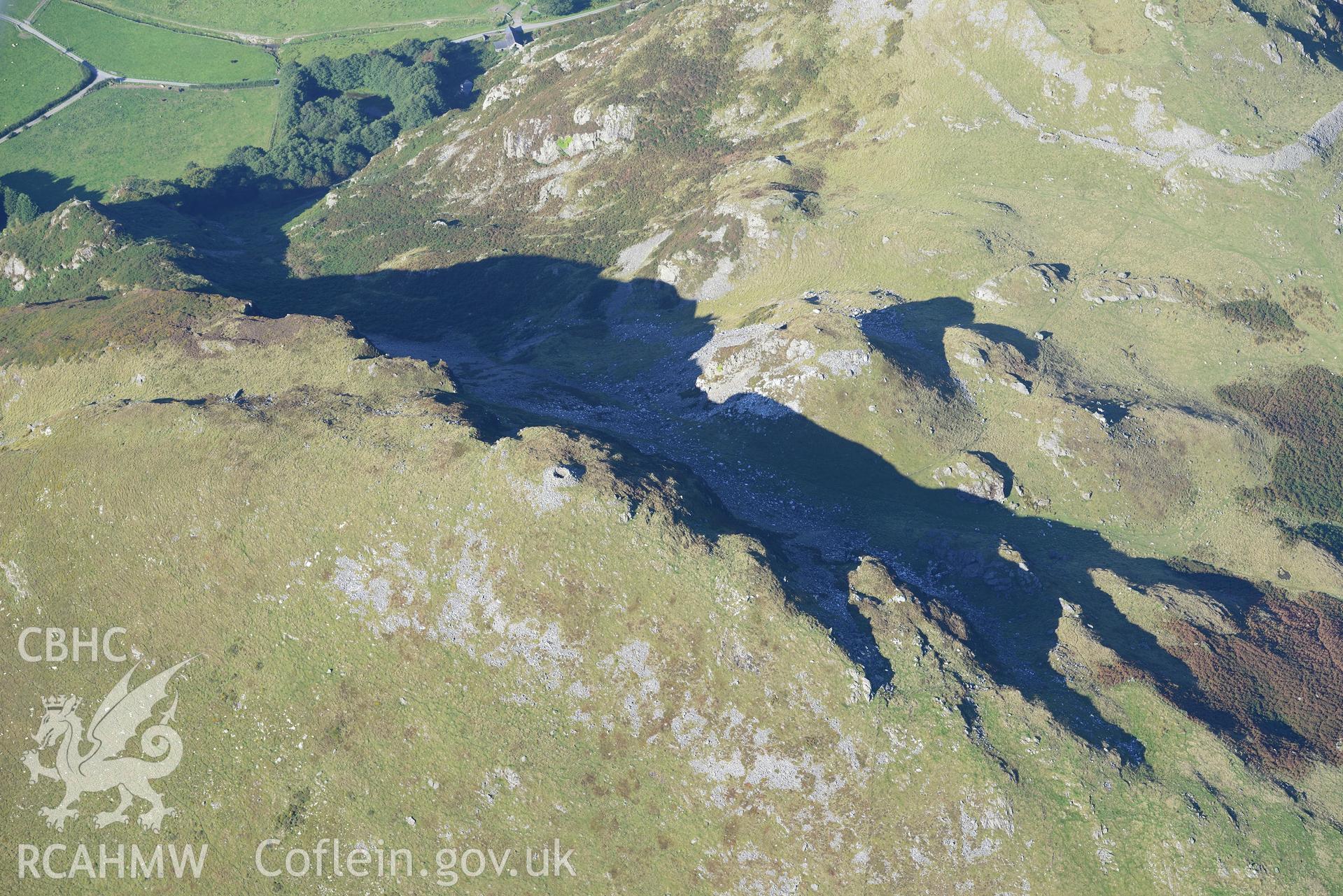 Craig yr Aderyn cairn, and a crag to its east, near Abergynolwyn. Oblique aerial photograph taken during the Royal Commission's programme of archaeological aerial reconnaissance by Toby Driver on 2nd October 2015.